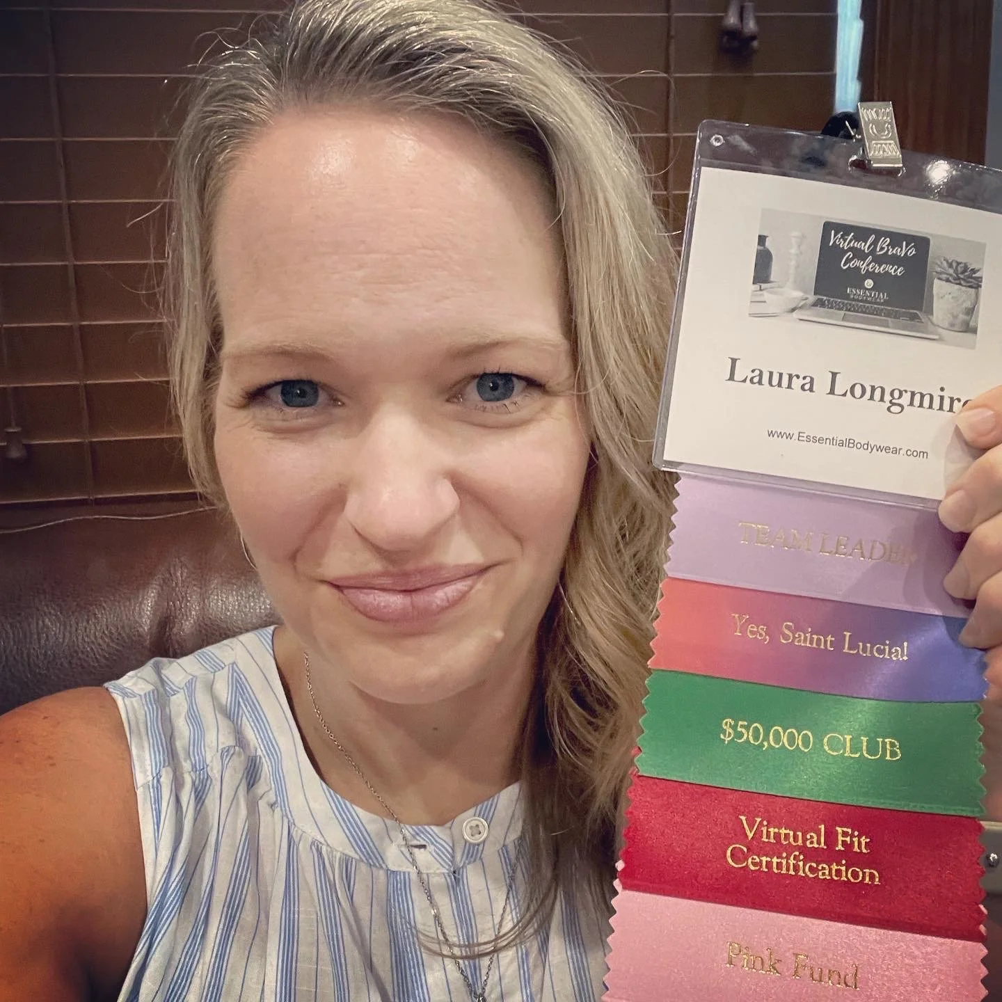 Personal wardrobe stylist Laura Longmire holding credentials for bra fitting certification