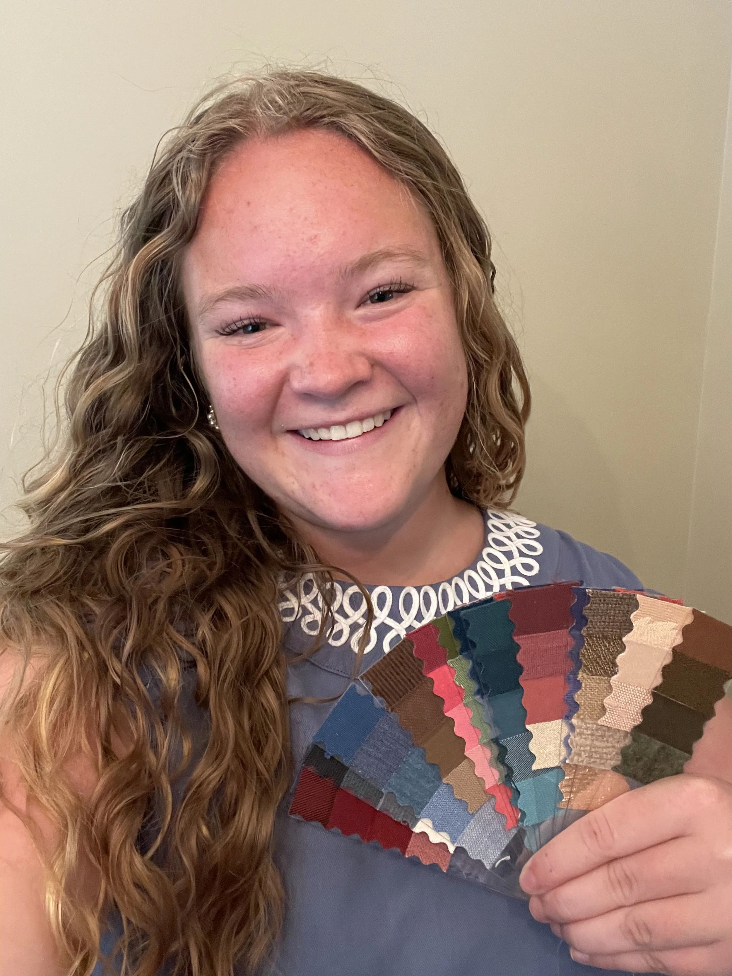 Young lady holds up custom fabric fan from her color analysis by Laura Longmire