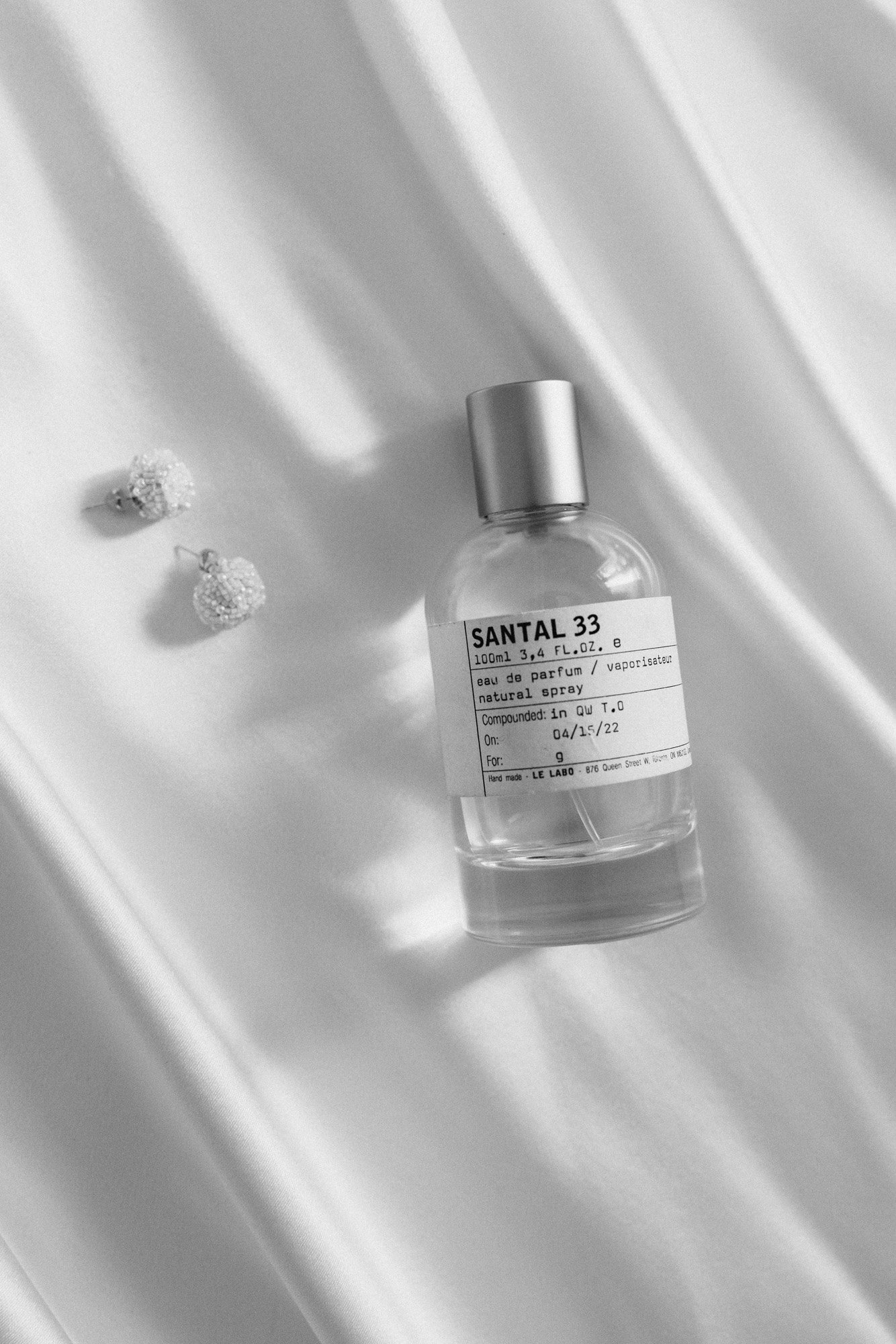  le labo perfume styled with ab ellie pearl earrings in a classic black and white flatlay in this getting ready shot at this modern wedding in italy. 