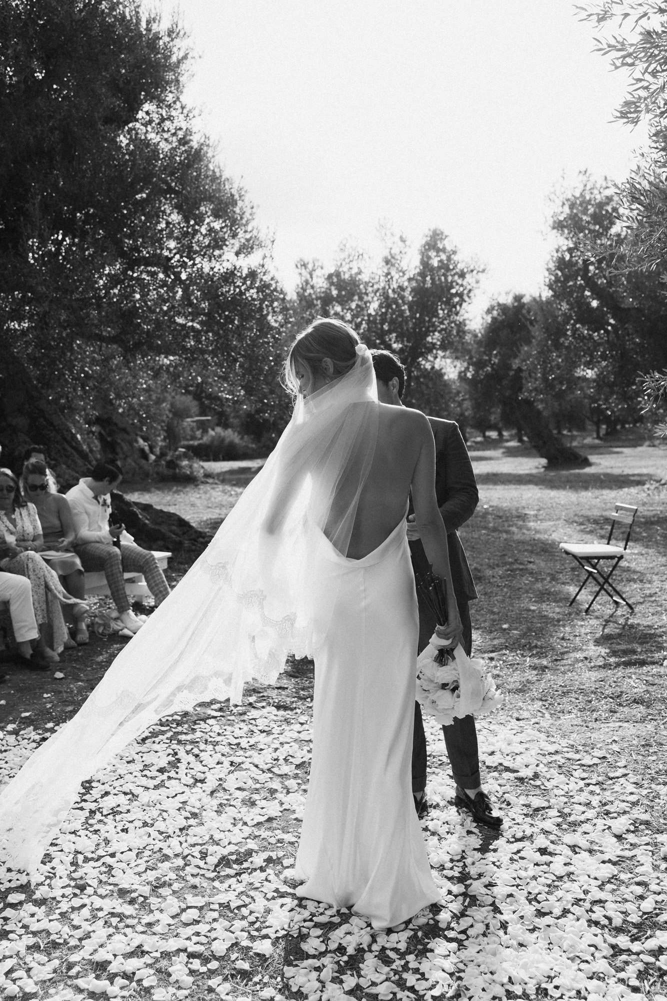 a modern take on a scattered flower petal aisle, in this classic black and white photo take an a modern italian wedding.