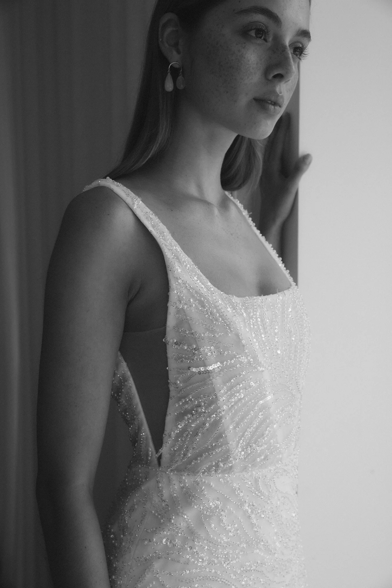 asymmetrical glass drop earrings by ab ellie styled with a beaded square neck gown by alena leena in a modern styled collection shoot.