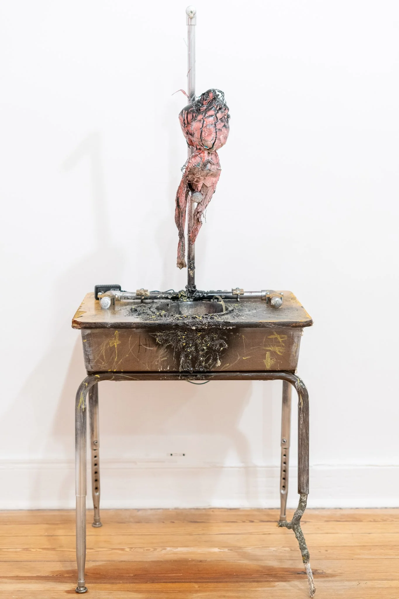 Jason Kash: Rehabilitation, 2025. Mixed media, found objects,
peristaltic pump, stick, and motor
oil.