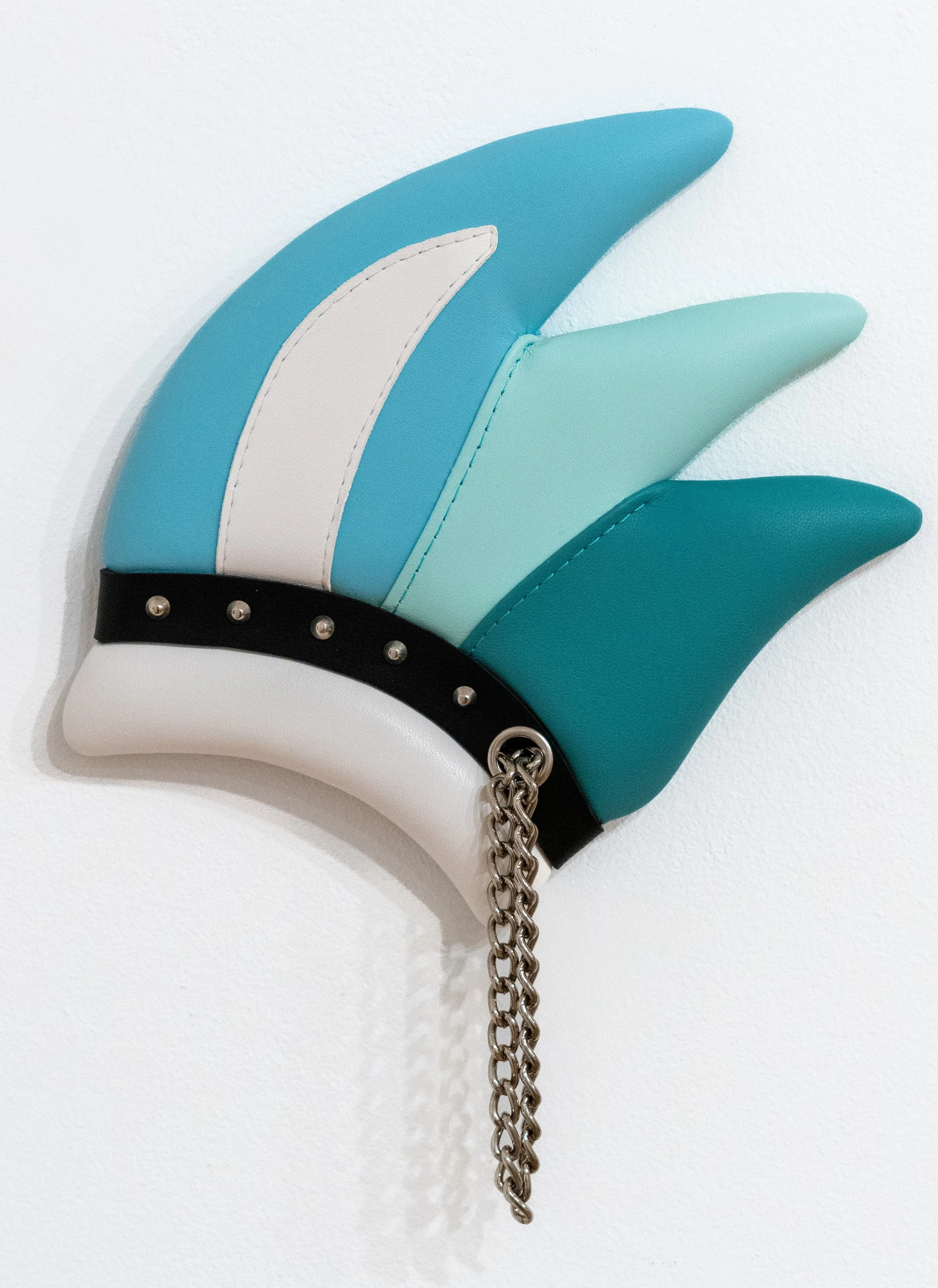Trish Tillman: Cuff (Cool), 2025. Leather, wood, foam, thread, chrome hardware, and chain; 12 x 9 ¾ x 1 inches.