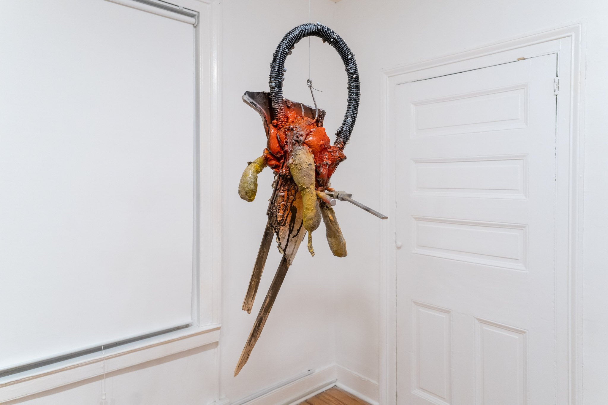 Jason Kash: Eternity, 2025. Mixed media, found objects, clamp, wire, and fish hook. 