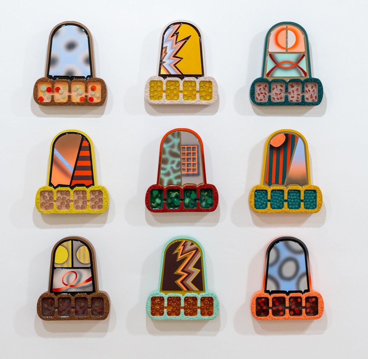Jana Cariddi: Unit 1–10, 2026. Acrylic, pumice stone, resin, marbles, plastic beans, and bingo chips on CNC milled wood; 10 ½ x 9 ½ inches, each.
