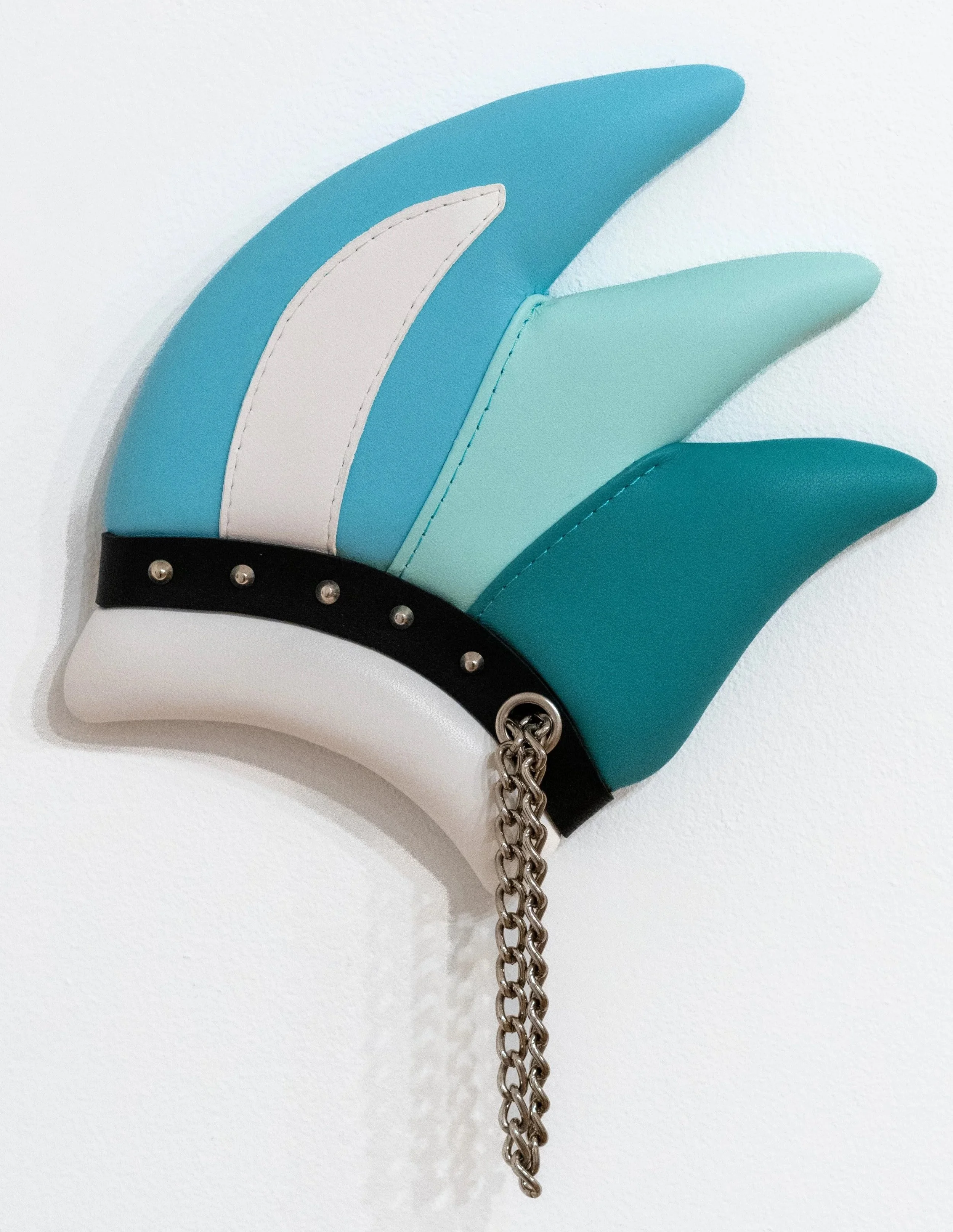 Trish Tillman: Cuff (Cool), 2025. Leather, wood, foam, thread, chrome hardware, and chain; 12 x 9 ¾ x 1 inches.
