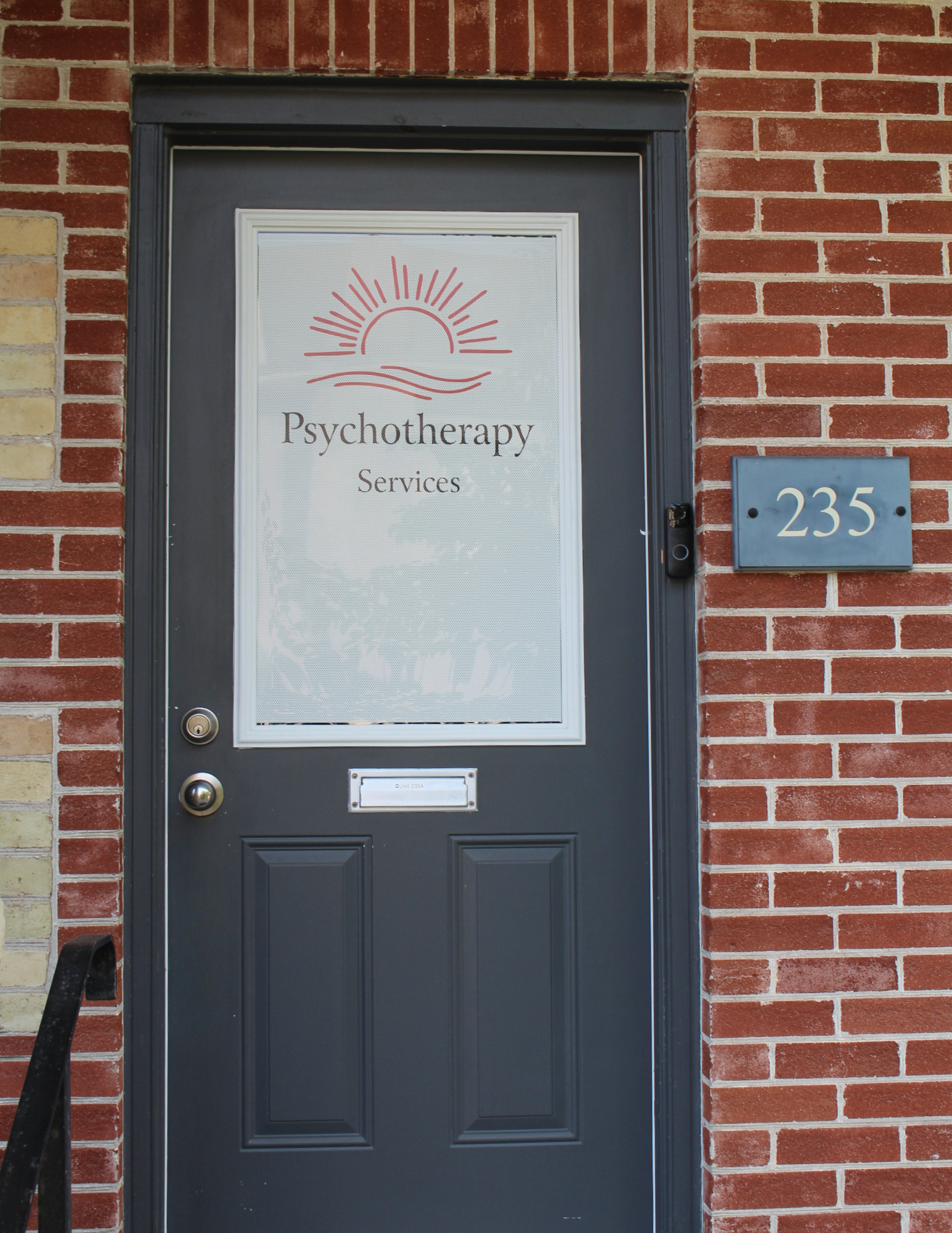 Door with sign saying Psychotherapy Services at 235 Frederick St Kitchener where Grace Brown provides counselling in Kitchener-Waterloo