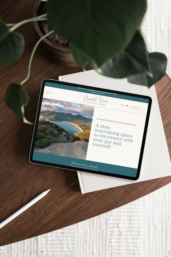 Chantel yates naturopath website design mockup on tablet sitting on a brown wood desk
