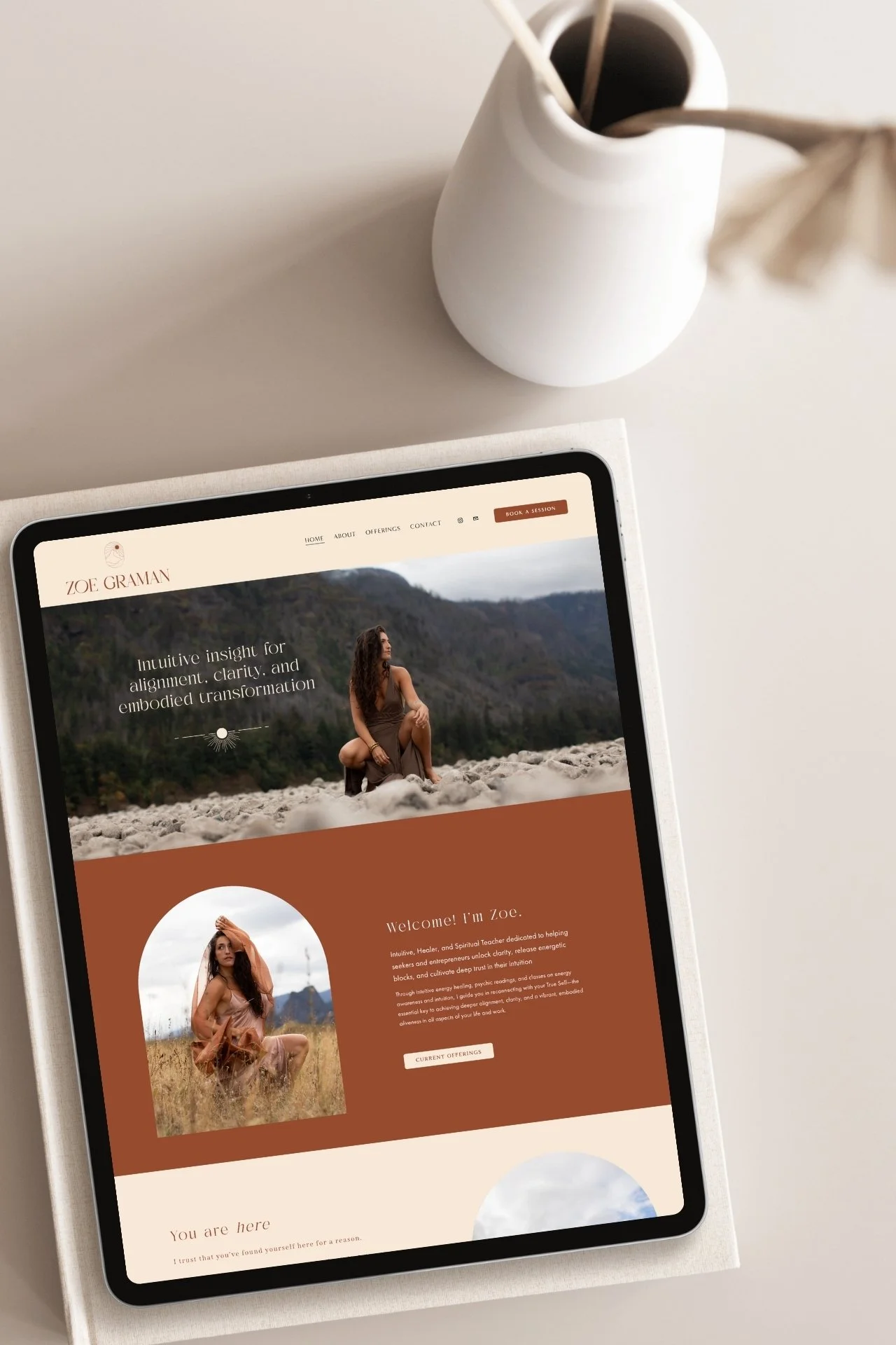 Zoe Graman website design mockup on ipad sitting on a table