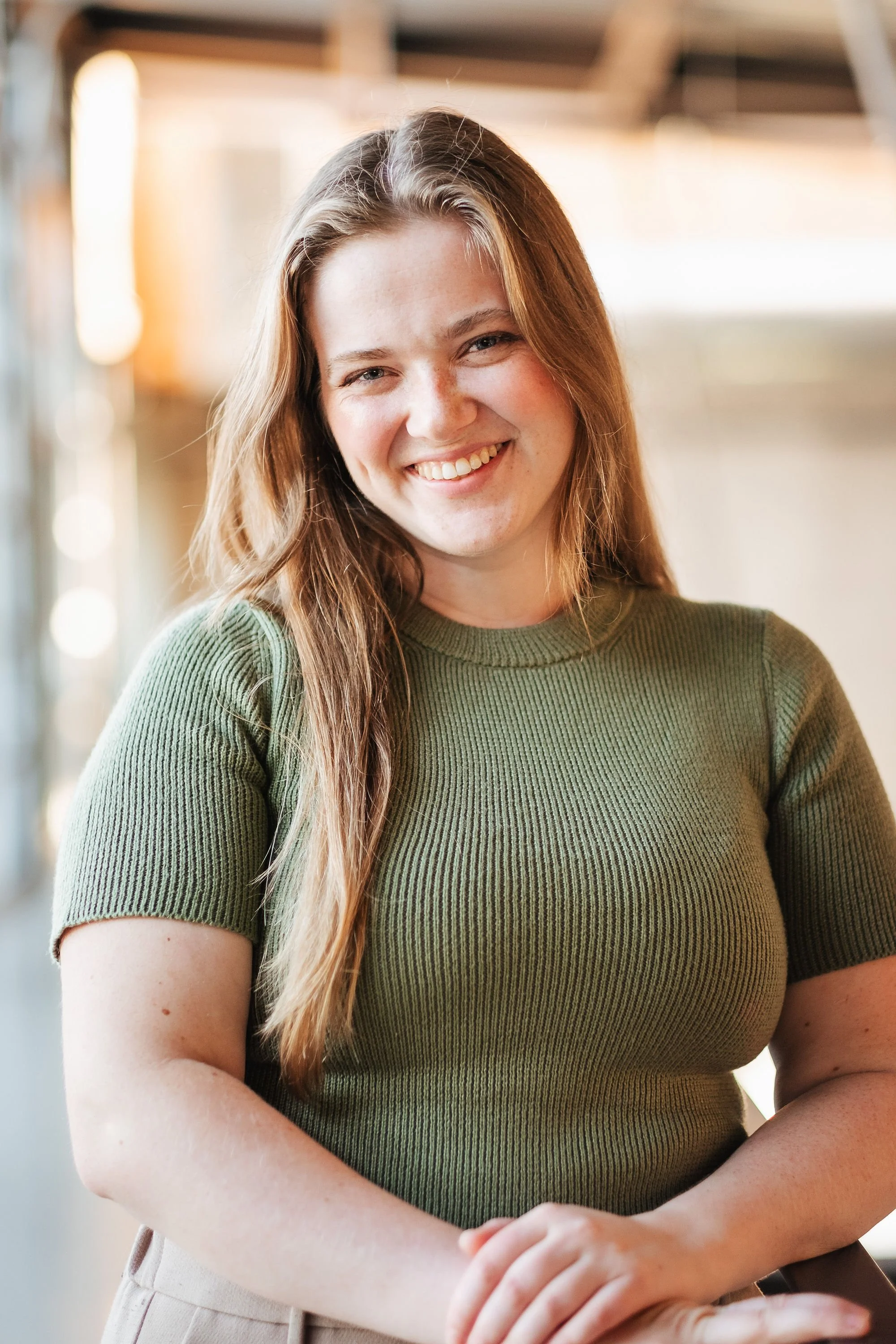 An image of a white woman, with long blonde/brunette hair.