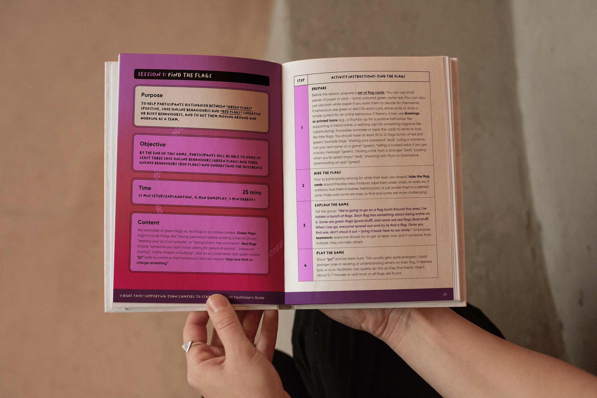 A person holding a book open which is the U Right Yaye? facilitator's guide detailing lesson plans to support young people to identify technology-facilitated abuse and respond to it.
