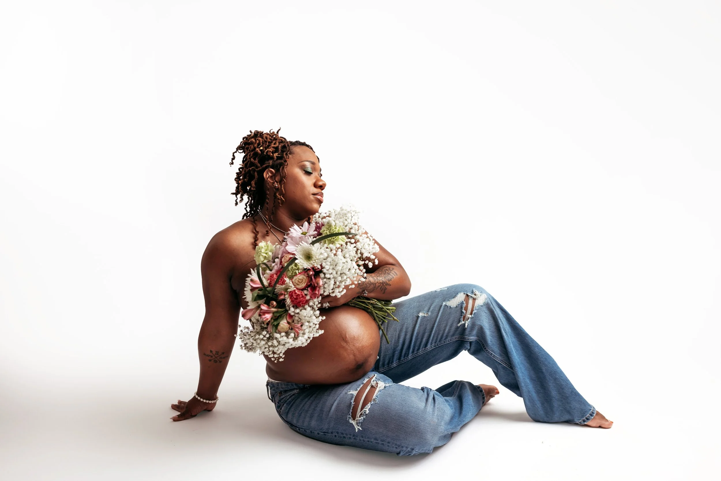 Studio maternity session in Jacksonville Florida with flowers and natural minimal styling