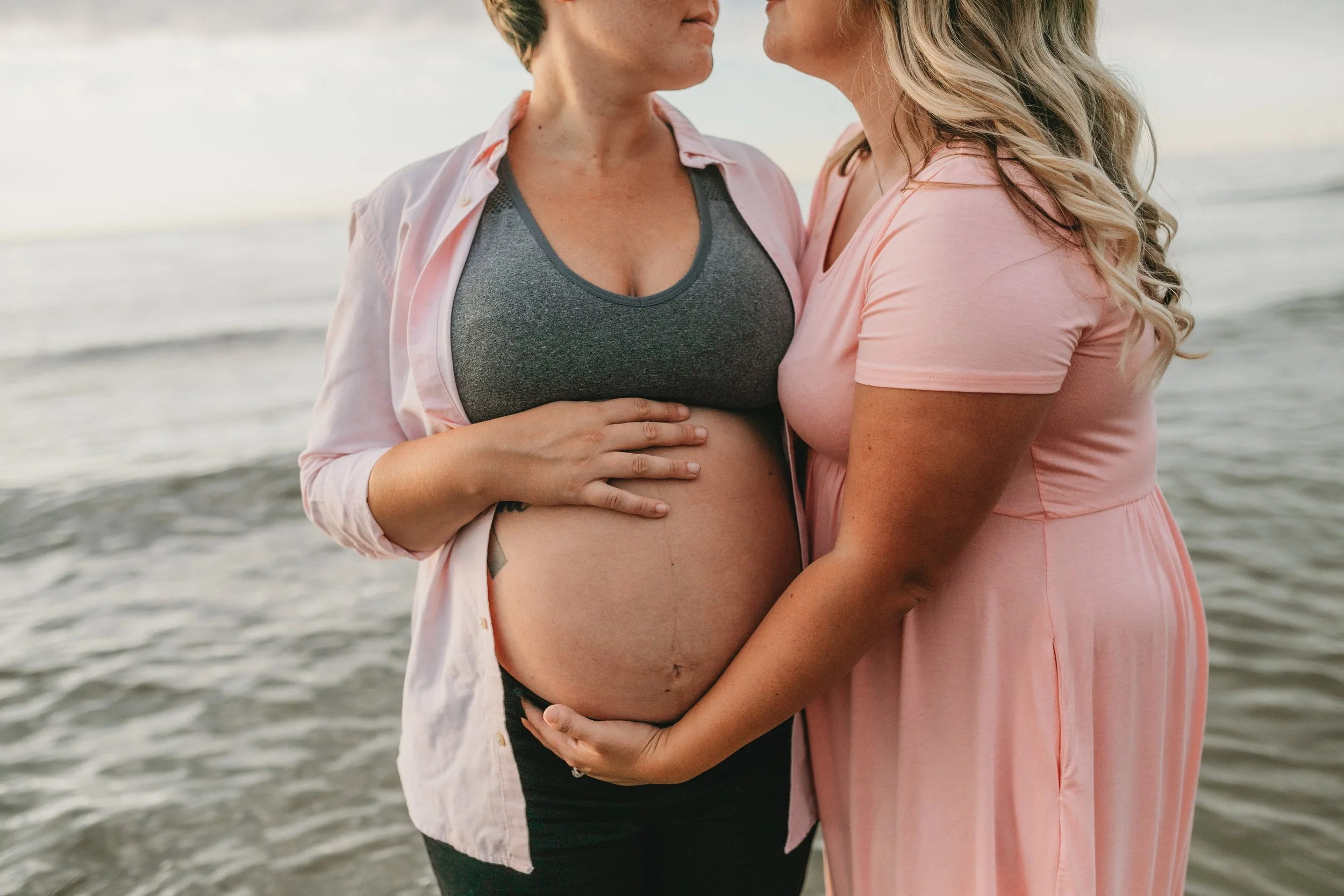 LGBTQ couple maternity session at Jacksonville Beach Florida during sunset by the ocean