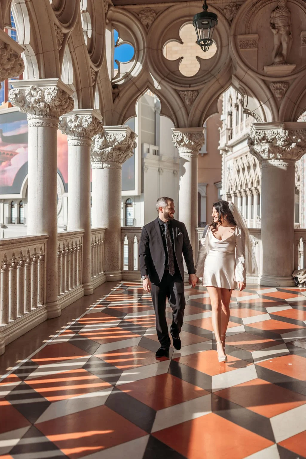 Stephanie and Gary walk together through the Venetian during their elopement