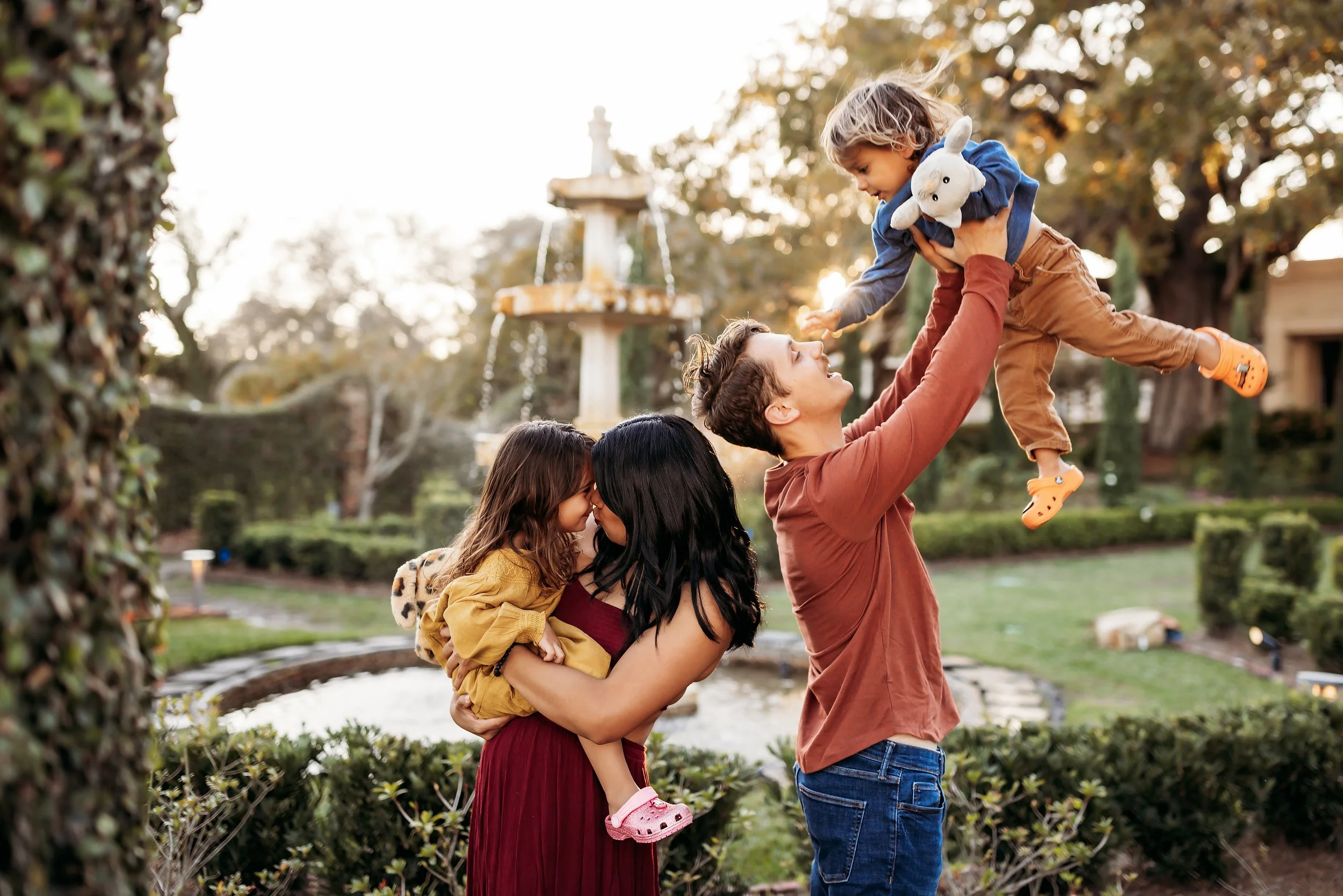 Family with young children playing near fountain during session at Cummer Museum and Gardens in Jacksonville Florida