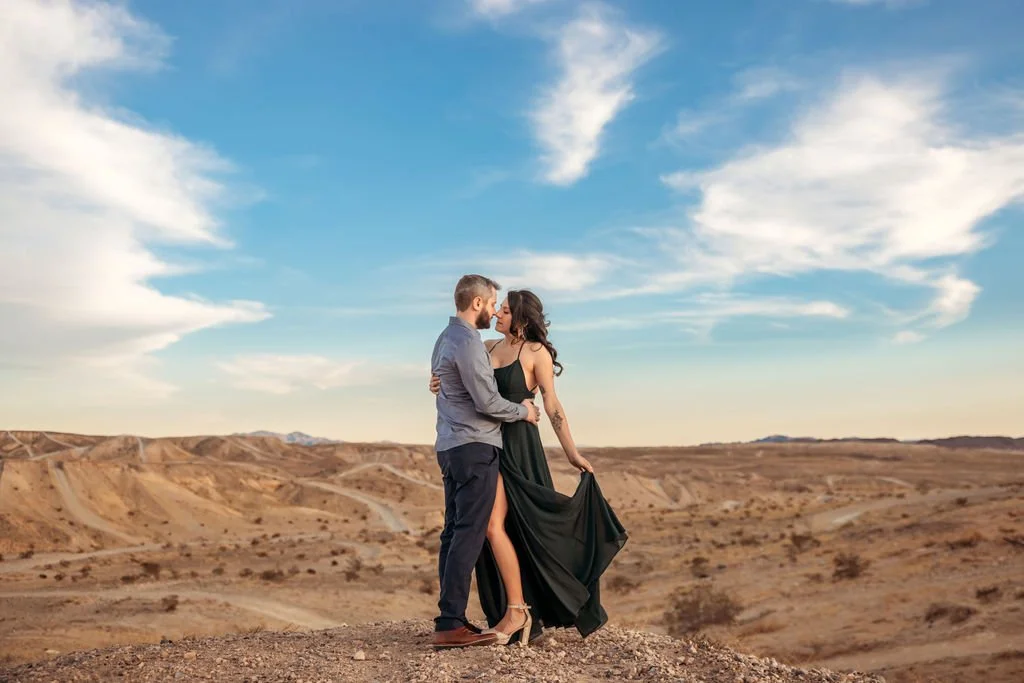 Stephanie and Gary embrace in the Las Vegas desert at sunset