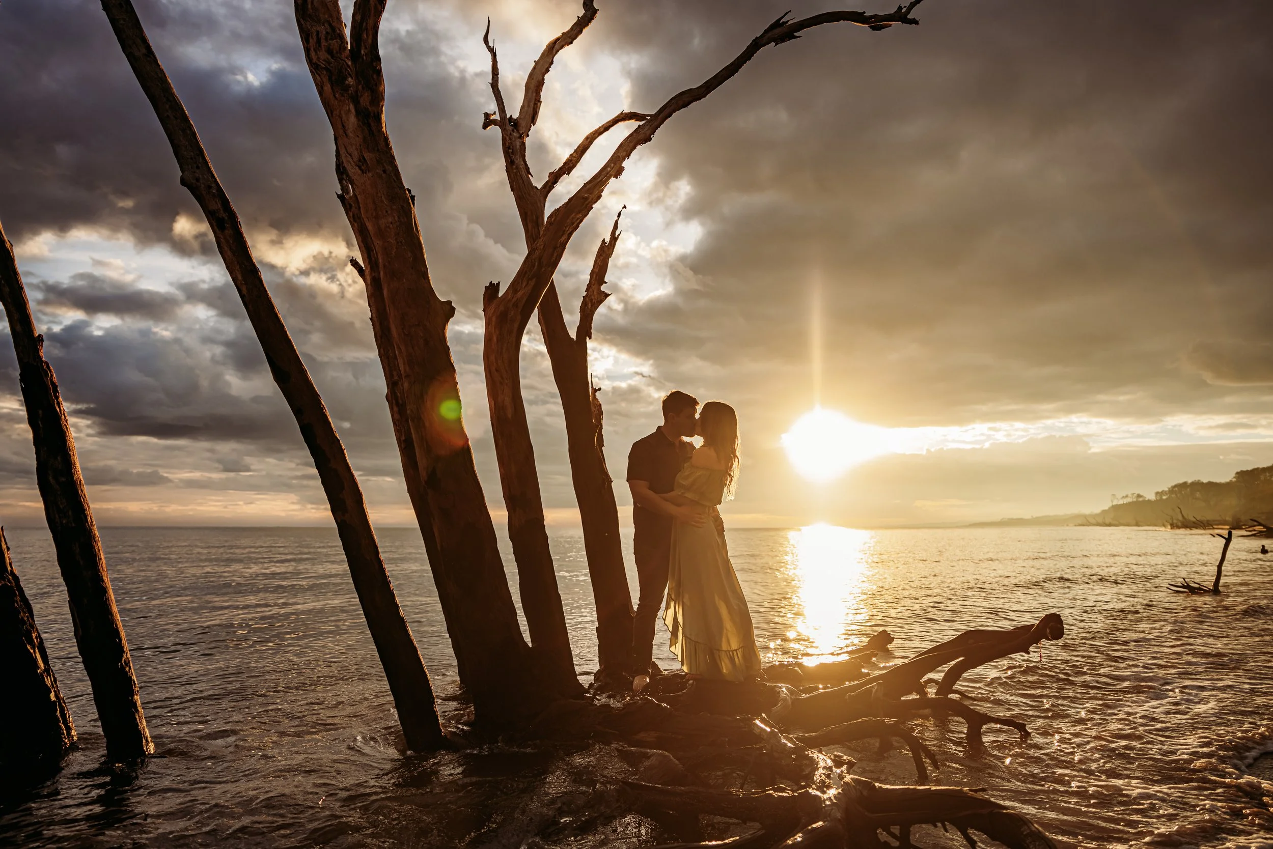 Couple kissing at sunset on Boneyard Beach in Big Talbot Island State Park, Jacksonville Florida during an engagement session
