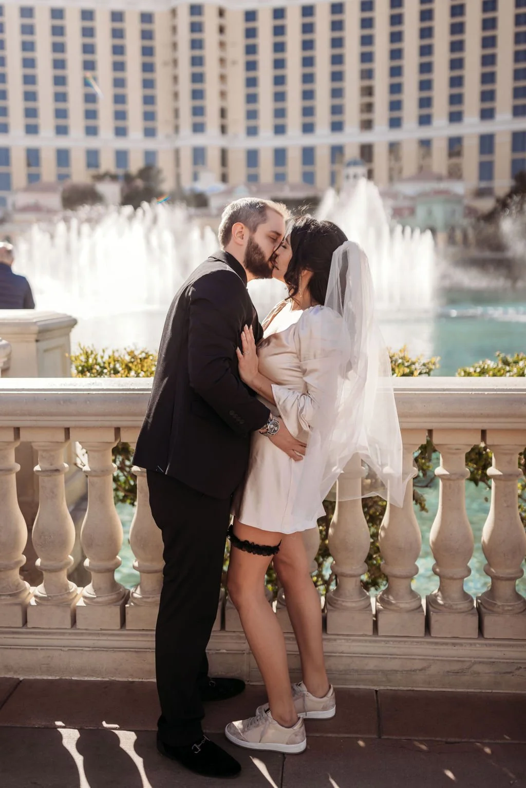 The newlyweds pose together beside the Bellagio fountains in Las Vegas