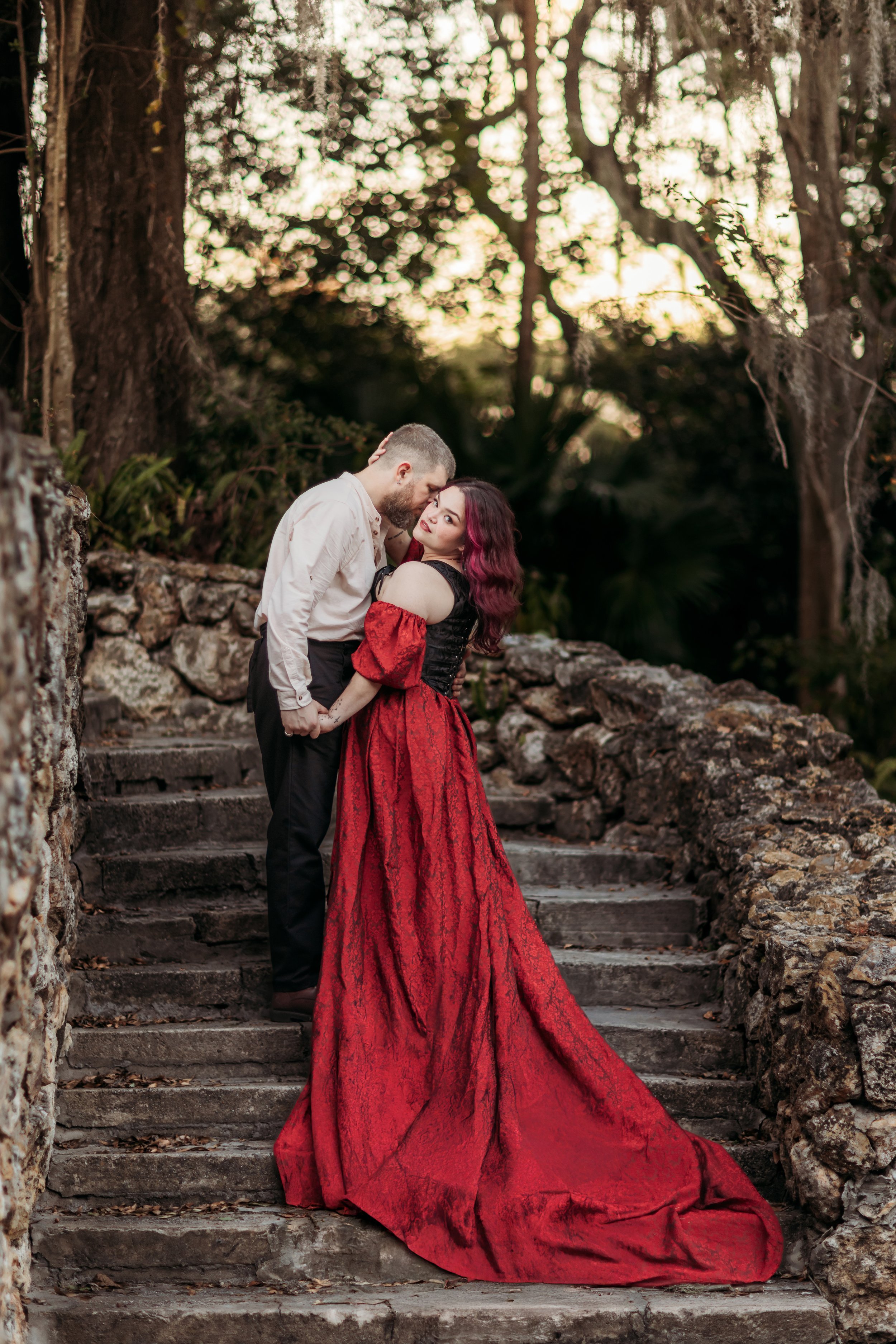 Couple embracing on stone steps at Ravine Gardens State Park in Palatka, Florida during a romantic outdoor session