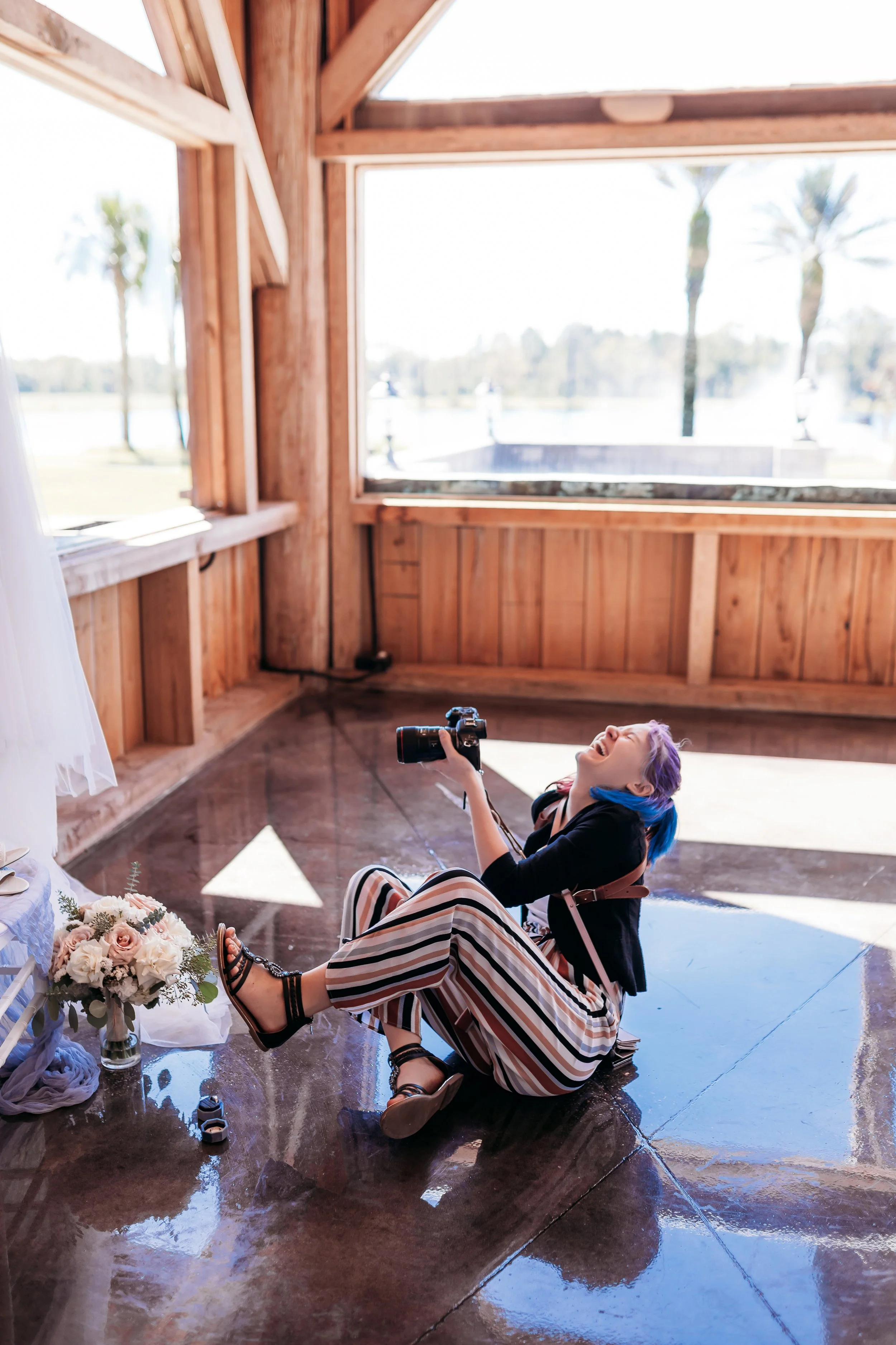 Candid moment of Jacksonville Florida wedding and elopement photographer Tiffany Joyce laughing on a wedding day while capturing photos