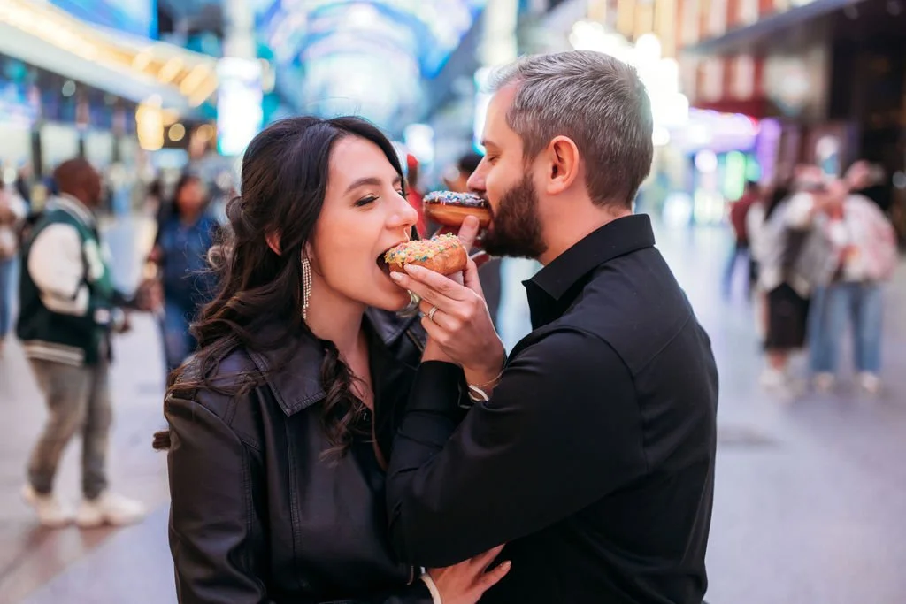 The newlyweds embrace during their nighttime Fremont Street portraits