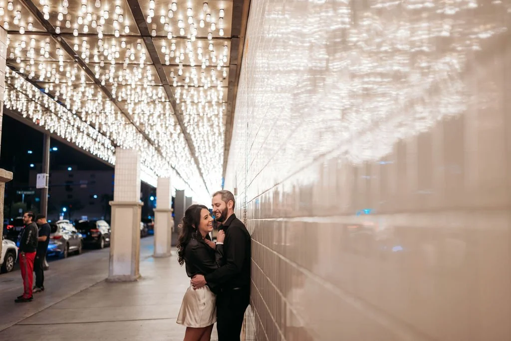 Stephanie and Gary embrace beneath the neon lights of Fremont Street