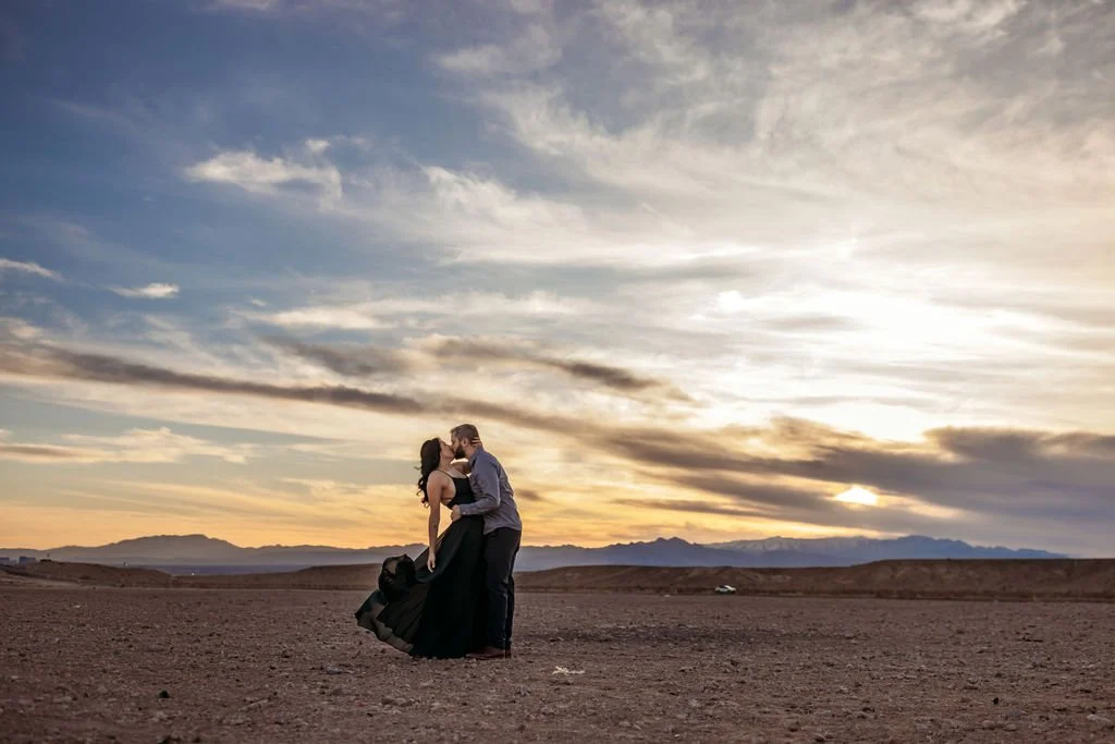 Stephanie and Gary hold each other in the desert at sunset