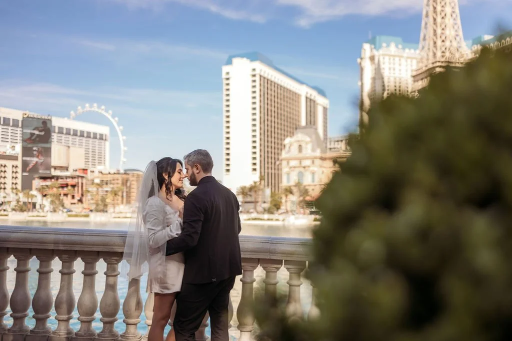 Stephanie and Gary stand together with the Bellagio fountains behind them