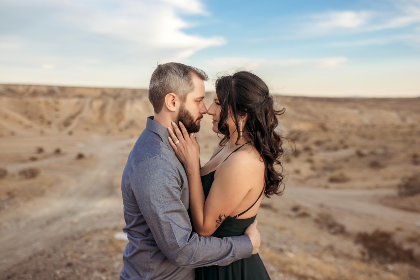 Stephanie and Gary pose together beneath the desert sunset near Las Vegas