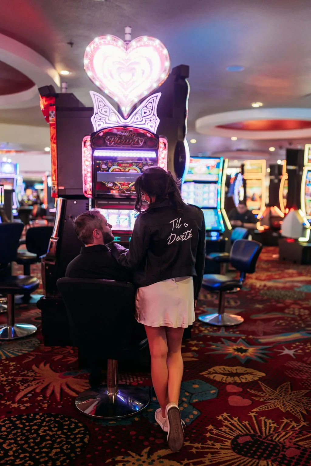 Stephanie and Gary hold each other outside a Fremont Street casino