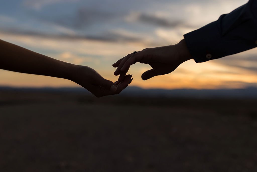 Close-up of Stephanie and Gary holding hands in the Las Vegas desert