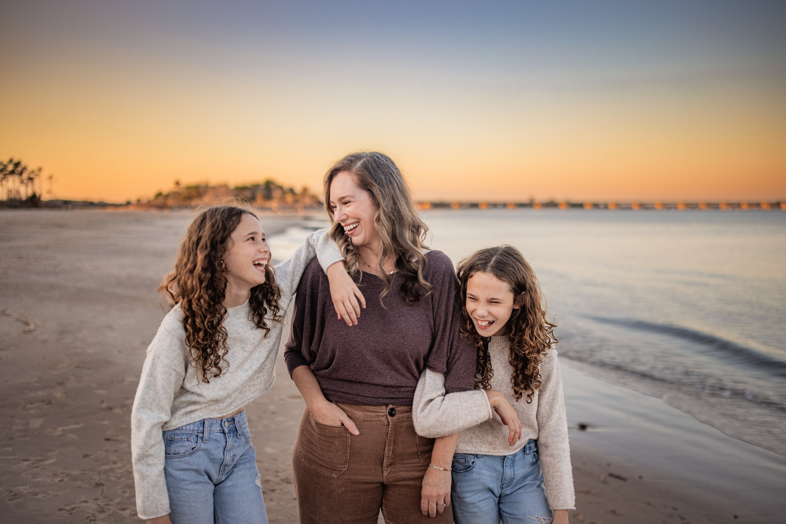 Mother laughing with children during sunset family session at Boneyard Beach on Big Talbot Island near Jacksonville Florida
