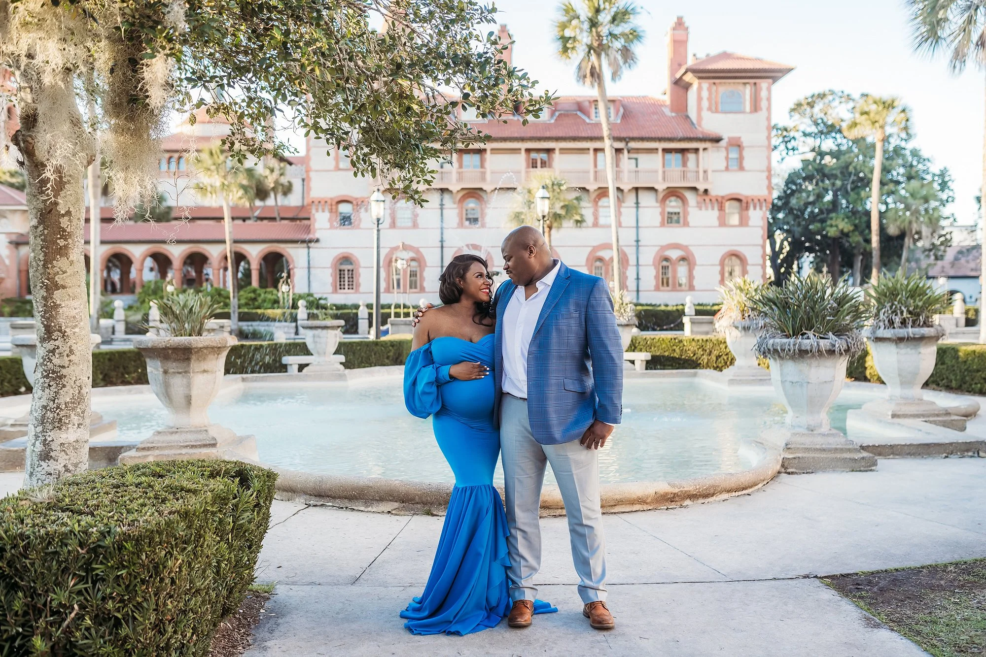Couple maternity session at Lightner Museum in St. Augustine Florida in front of historic fountain