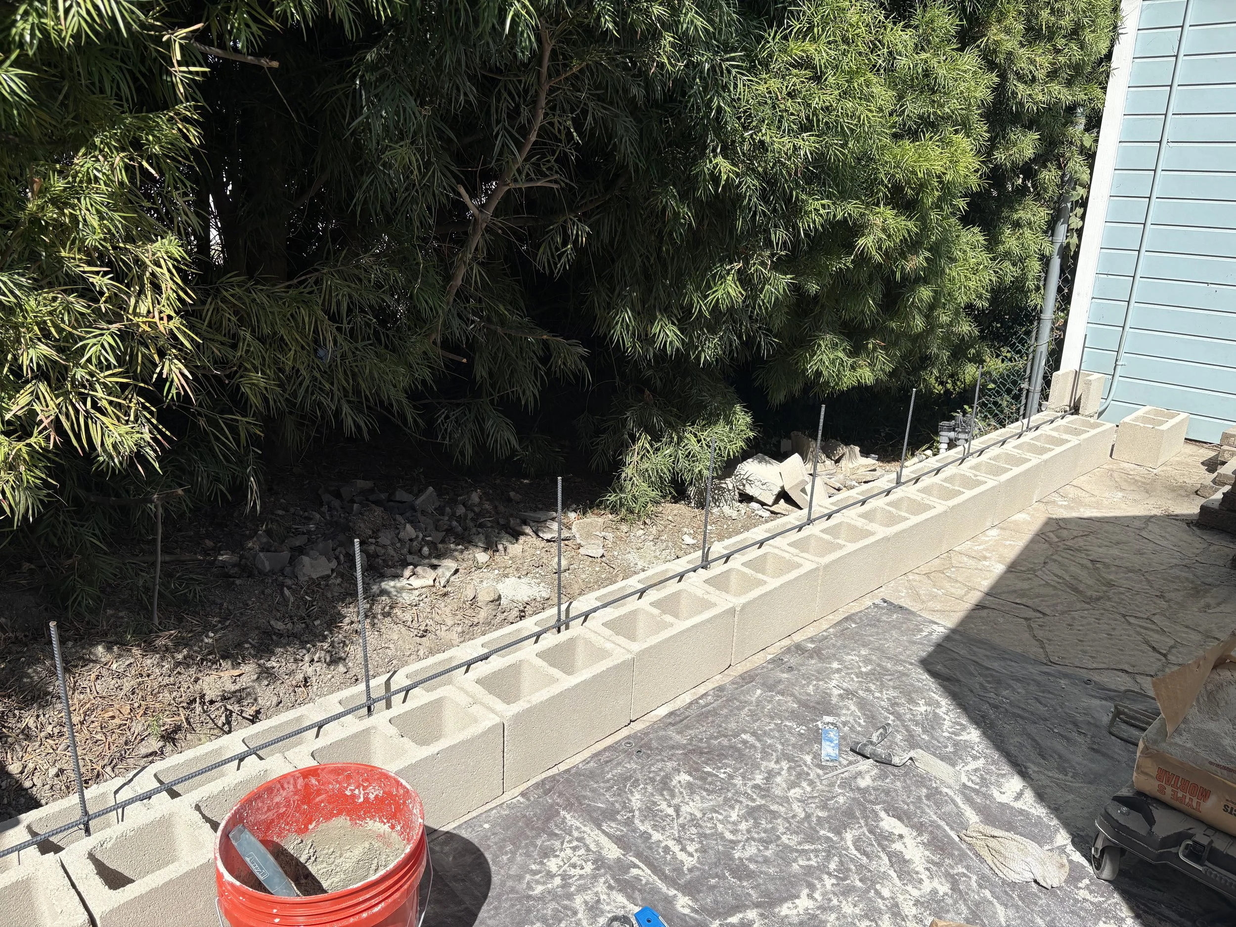 Blocks added, rebar tied throughout wall for stability