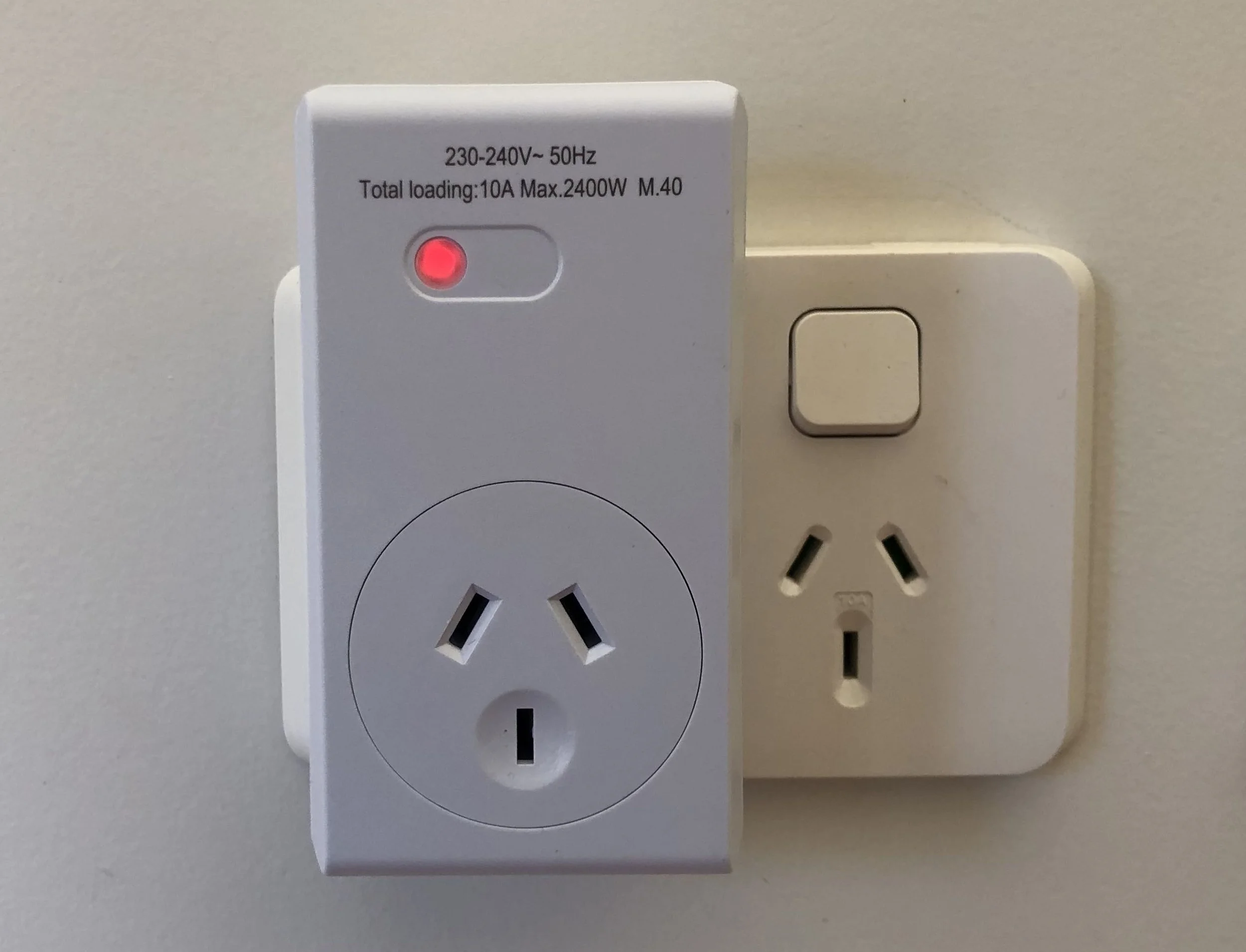 Remote controlled power socket plugged into a New Zealand wall outlet.