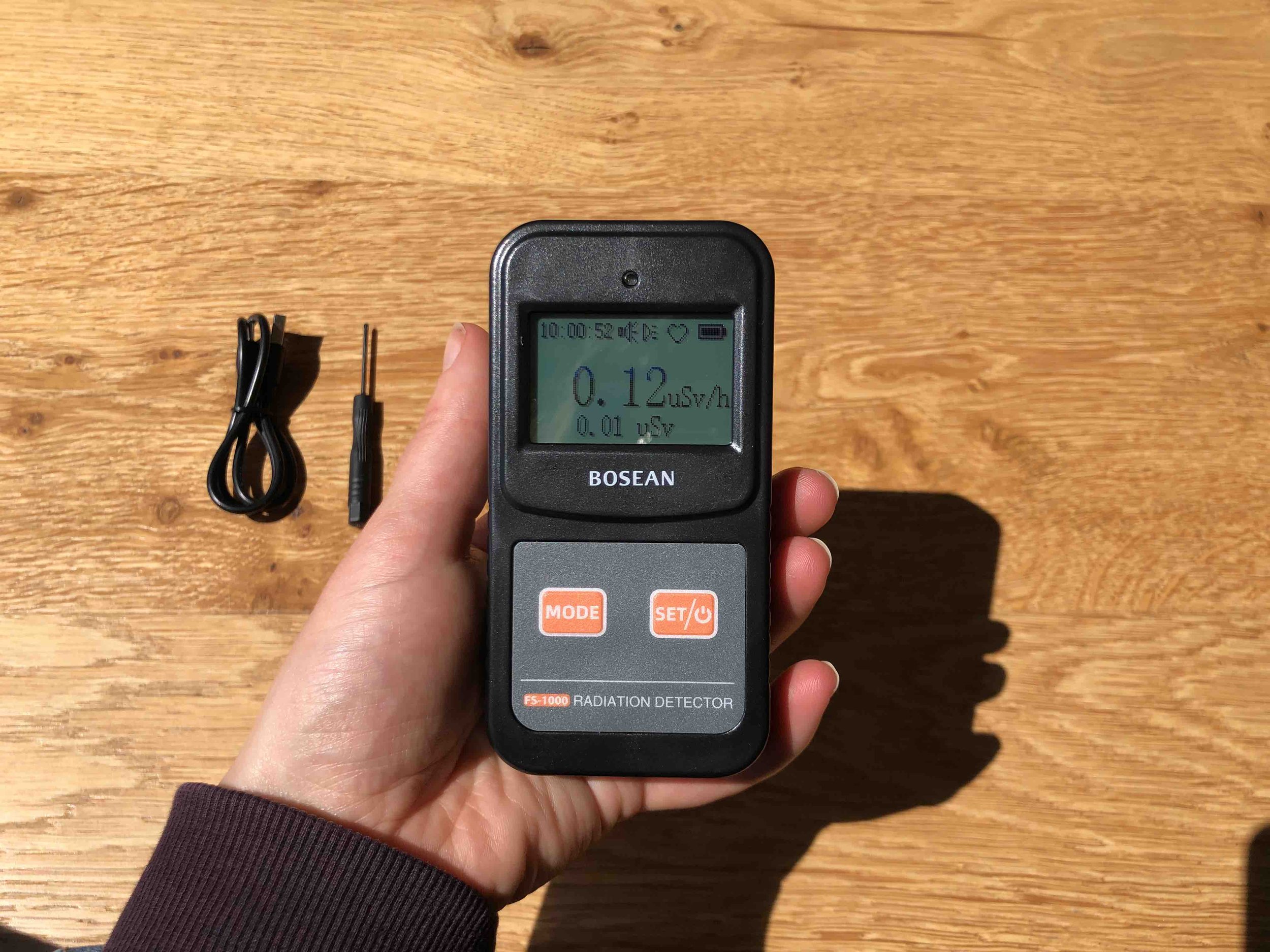 User measuring home radiation with FS1000 Geiger counter