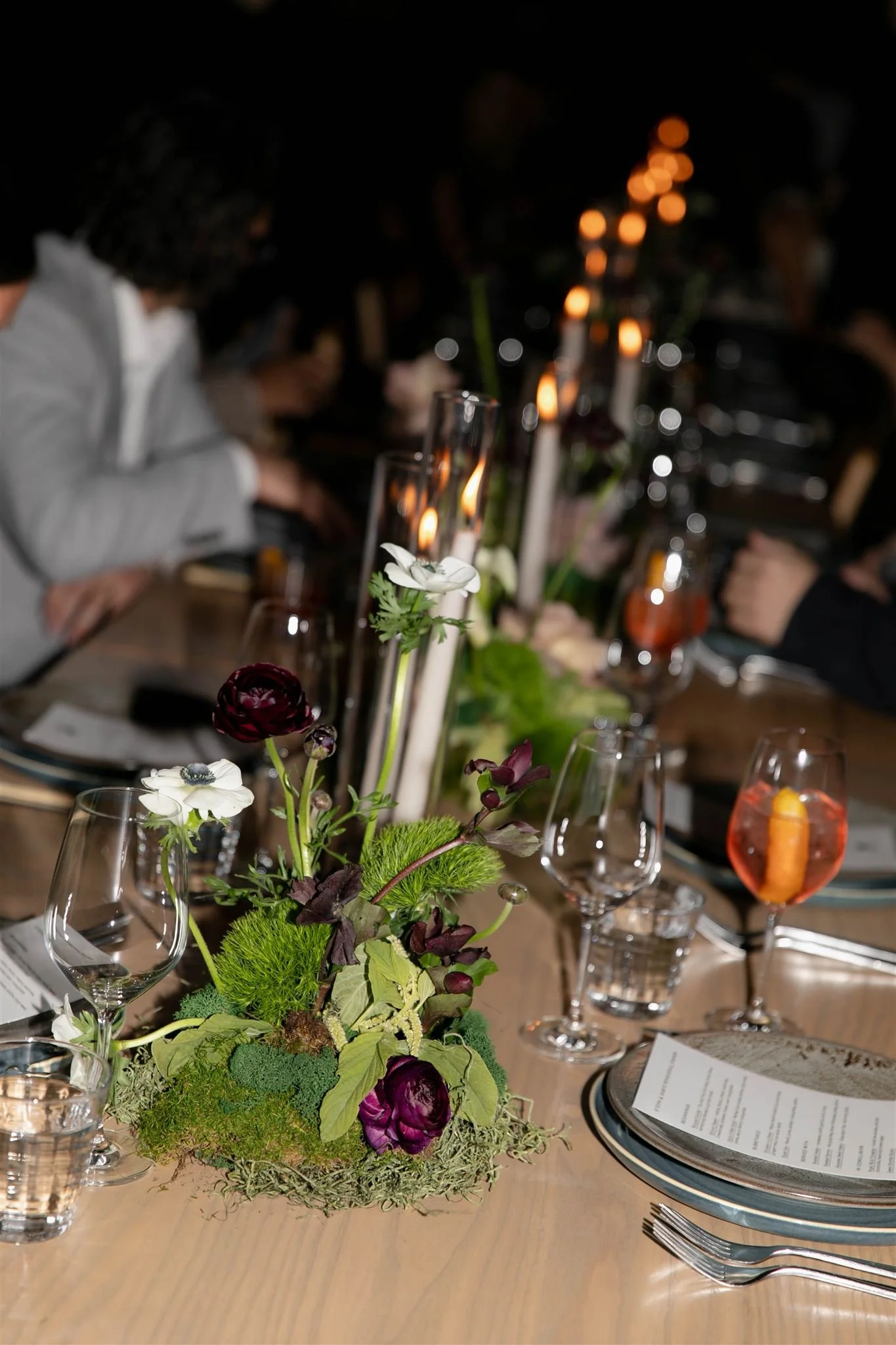 Wedding guests at a candlelit rehearsal dinner at Maxwells Trading Chicago wedding venue.