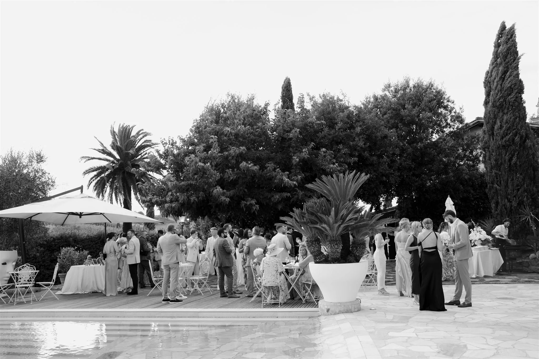 A poolside cocktail hour on a wedding day at Tenuta Corbinaia Villa in Tuscany, Italy.
