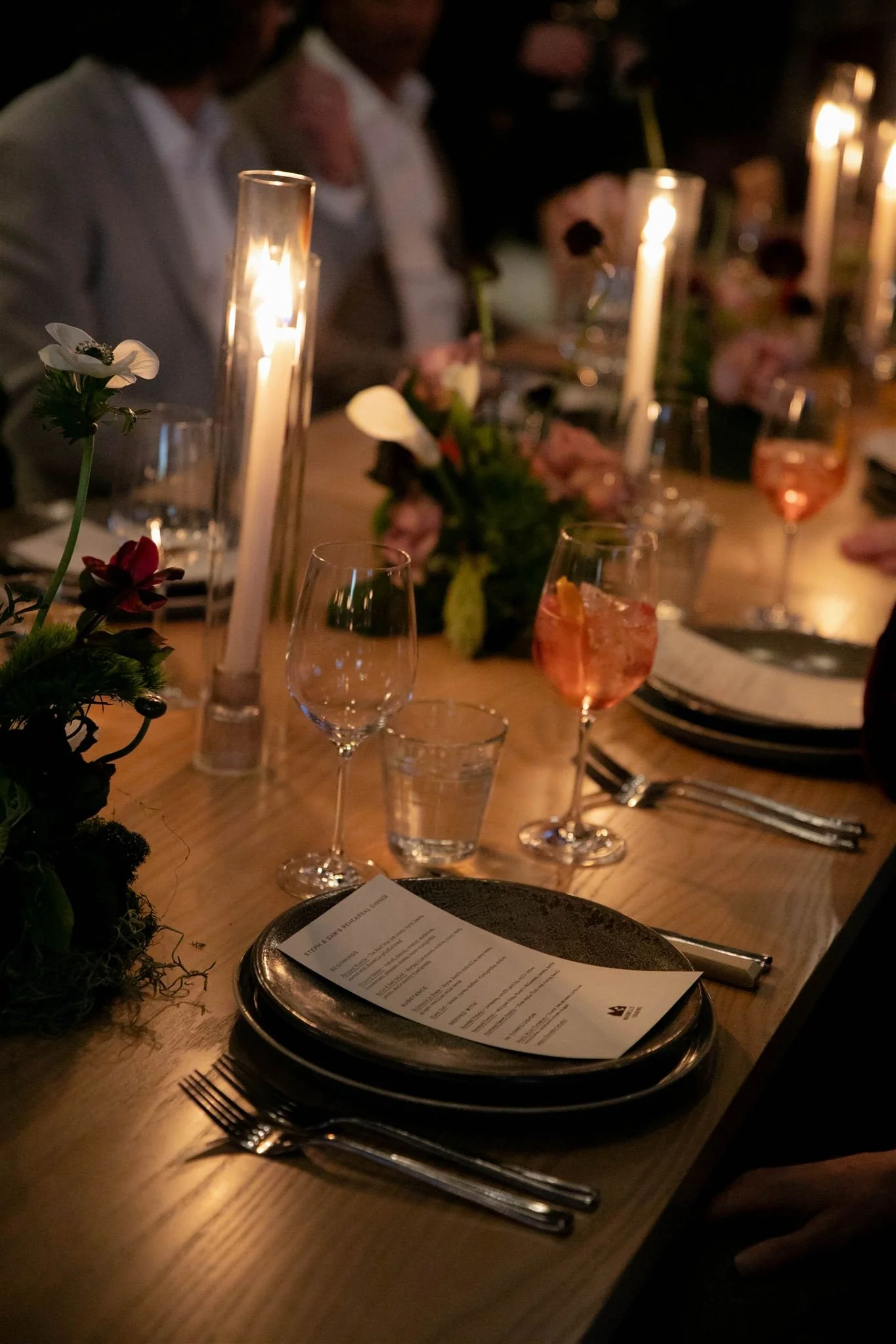 Wedding guests at a candlelit rehearsal dinner at Maxwells Trading Chicago wedding venue.