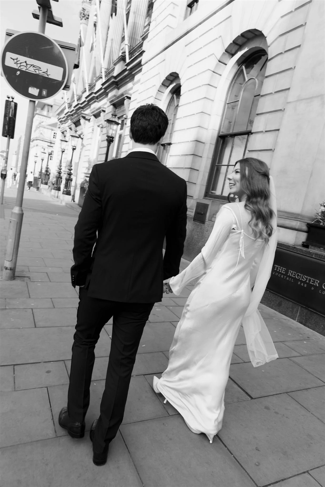 Bride and groom strolling around outside Edinburgh City Chambers, captured by an Edinburgh City Chambers wedding photographer in a natural style.