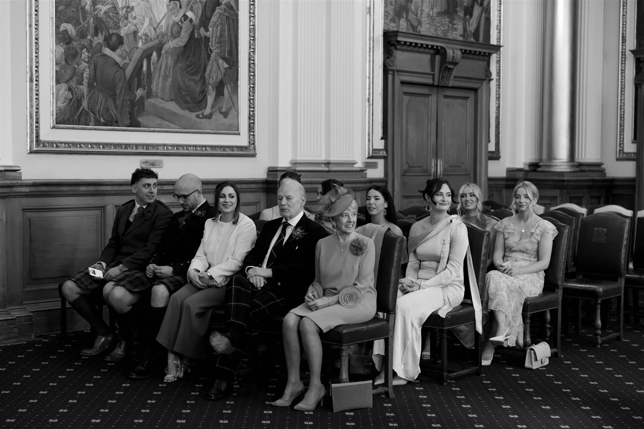 Wedding guests on a wedding day at Edinburgh City Chambers, photographed by an Edinburgh Scotland Wedding Photographer..