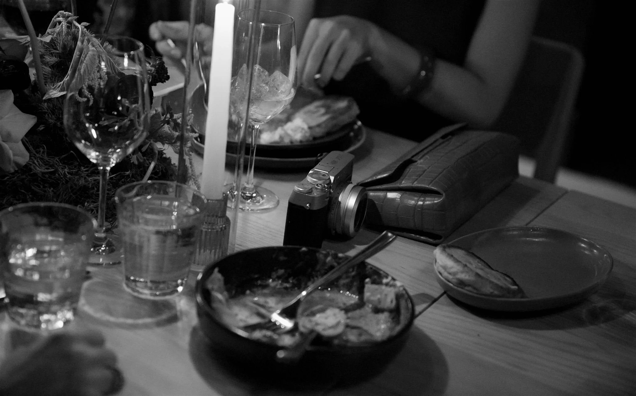 Wedding guests at a candlelit rehearsal dinner at Maxwells Trading Chicago wedding venue.