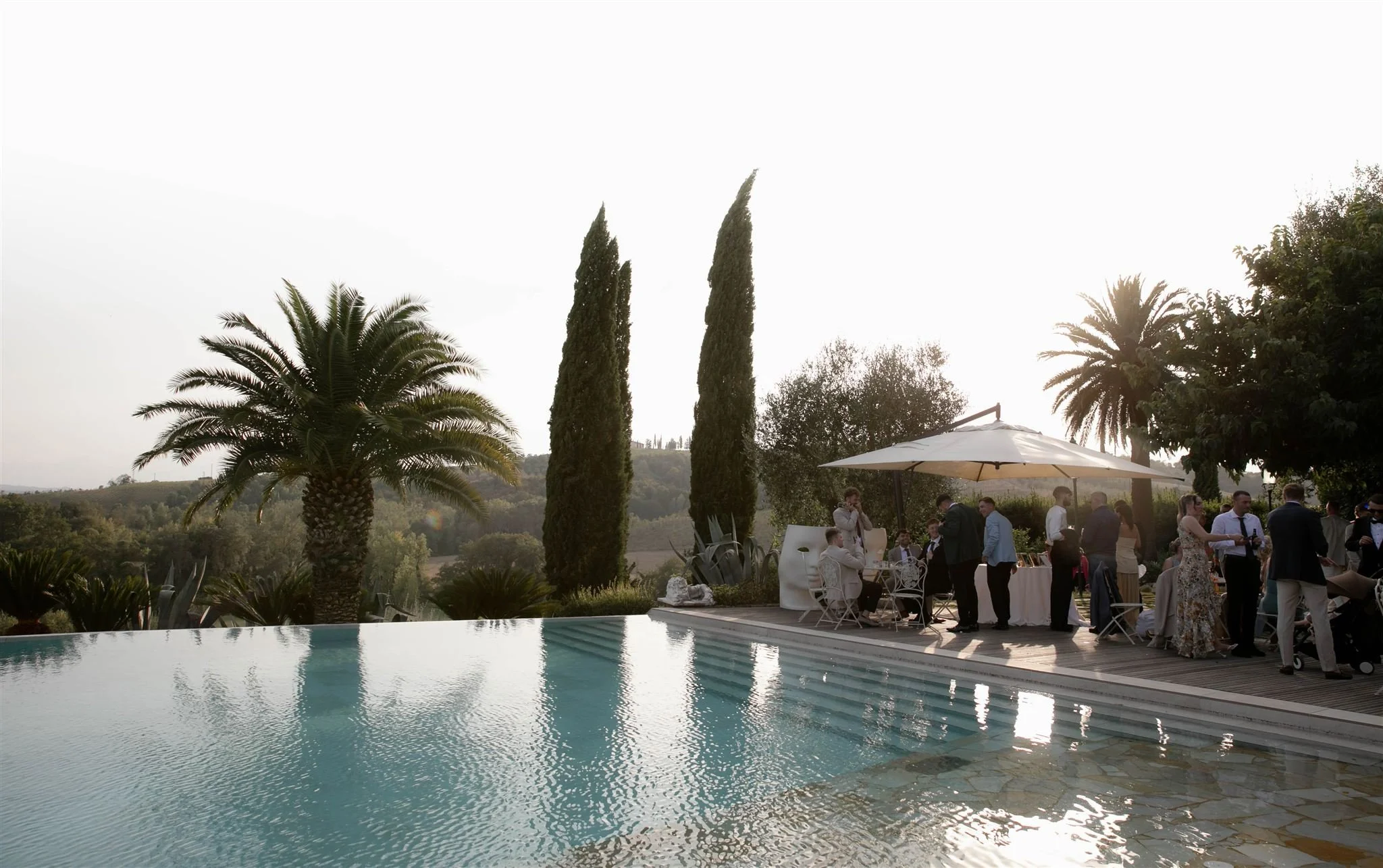 A poolside cocktail hour on a wedding day at Tenuta Corbinaia Villa in Tuscany, Italy.