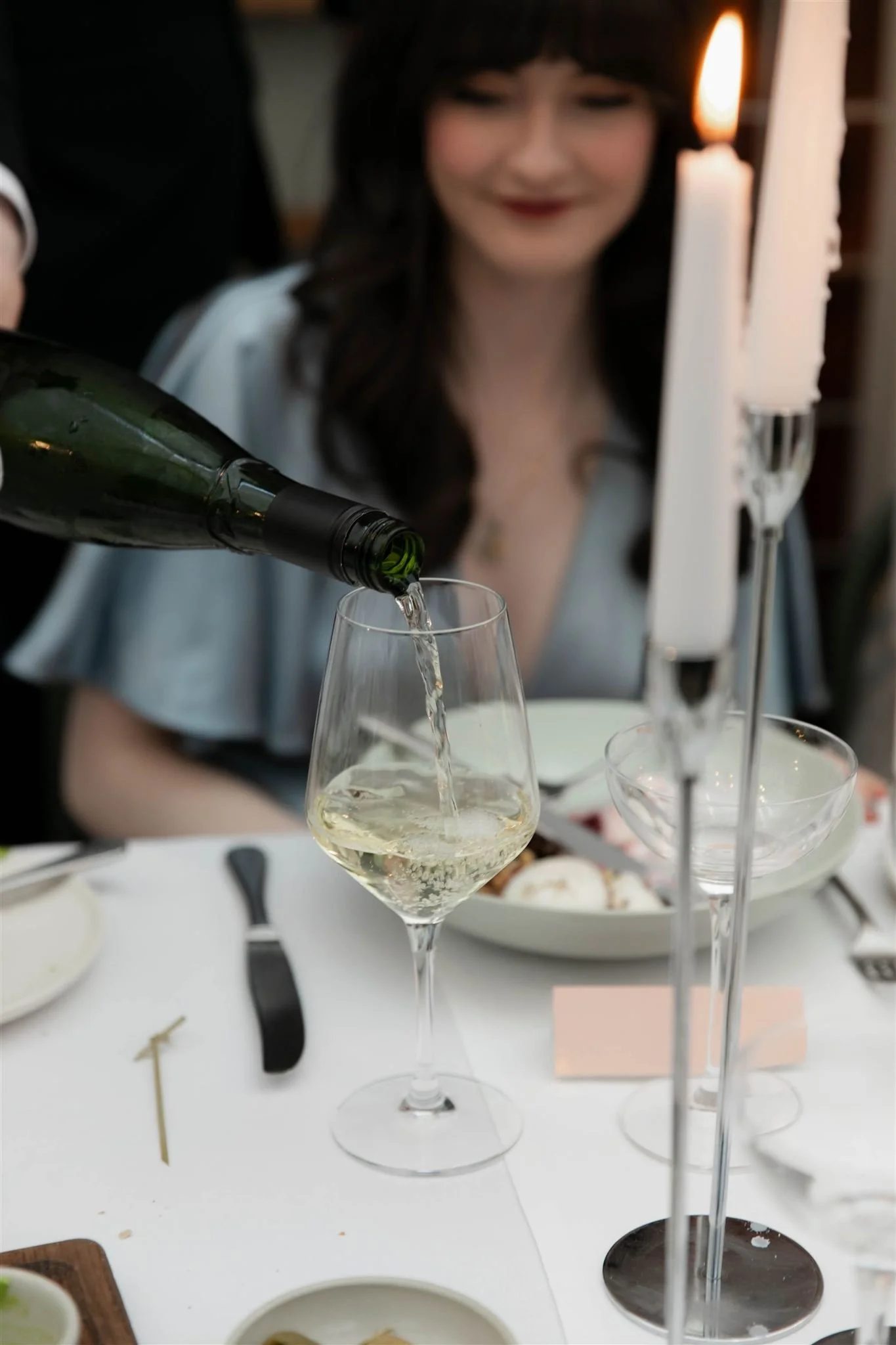 Wedding guest having wine at a reception dinner at Gleneagles Townhouse in Edinburgh following an Edinburgh City Chambers ceremony.