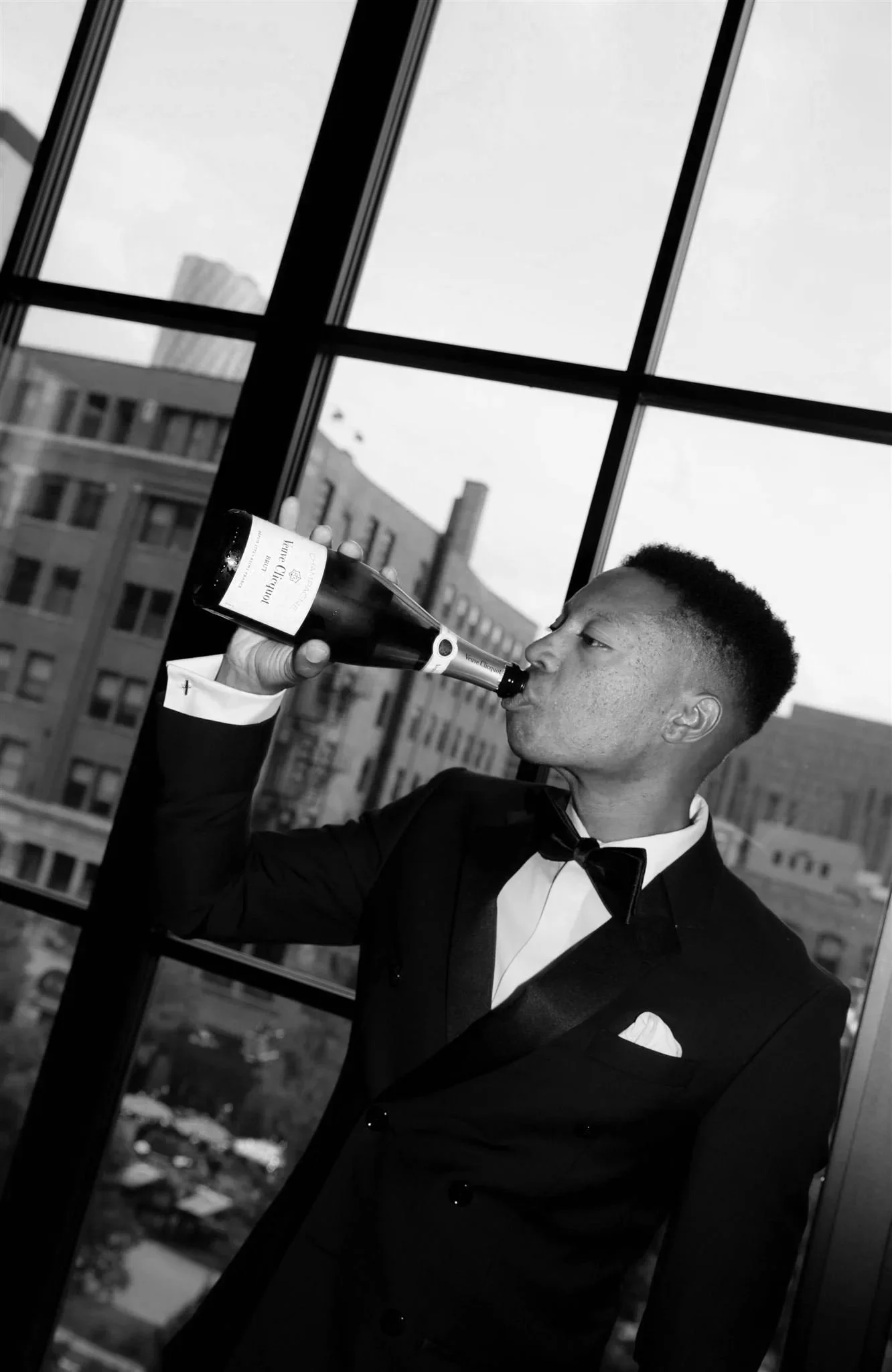 Groom drinking champagne at Nobu Hotel on a wedding day in Chicago.