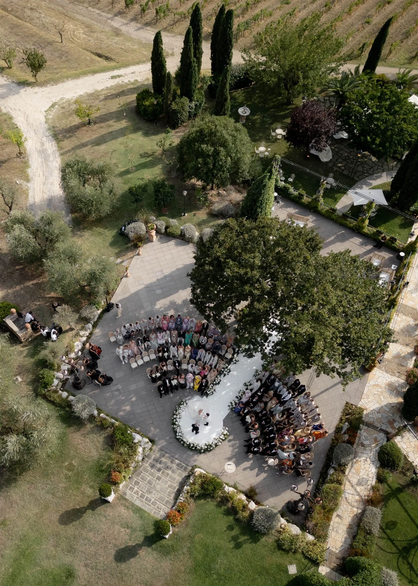 An outdoor wedding ceremony at Tenuta Corbinaia Villa in Tuscany, Italy.
