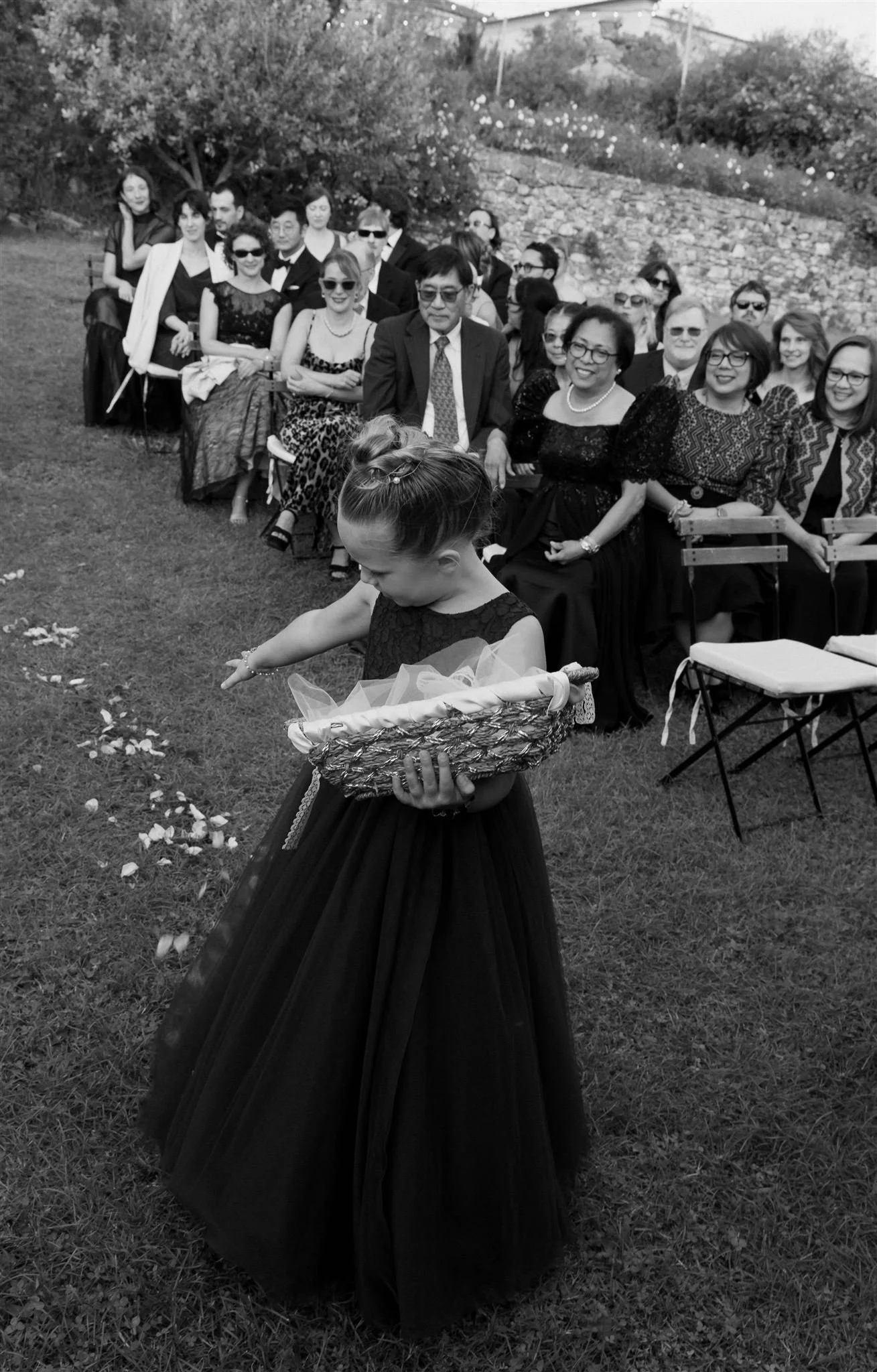 Flower girl on a wedding day at Villa Medicea Di Lilliano in Tuscany, Italy.