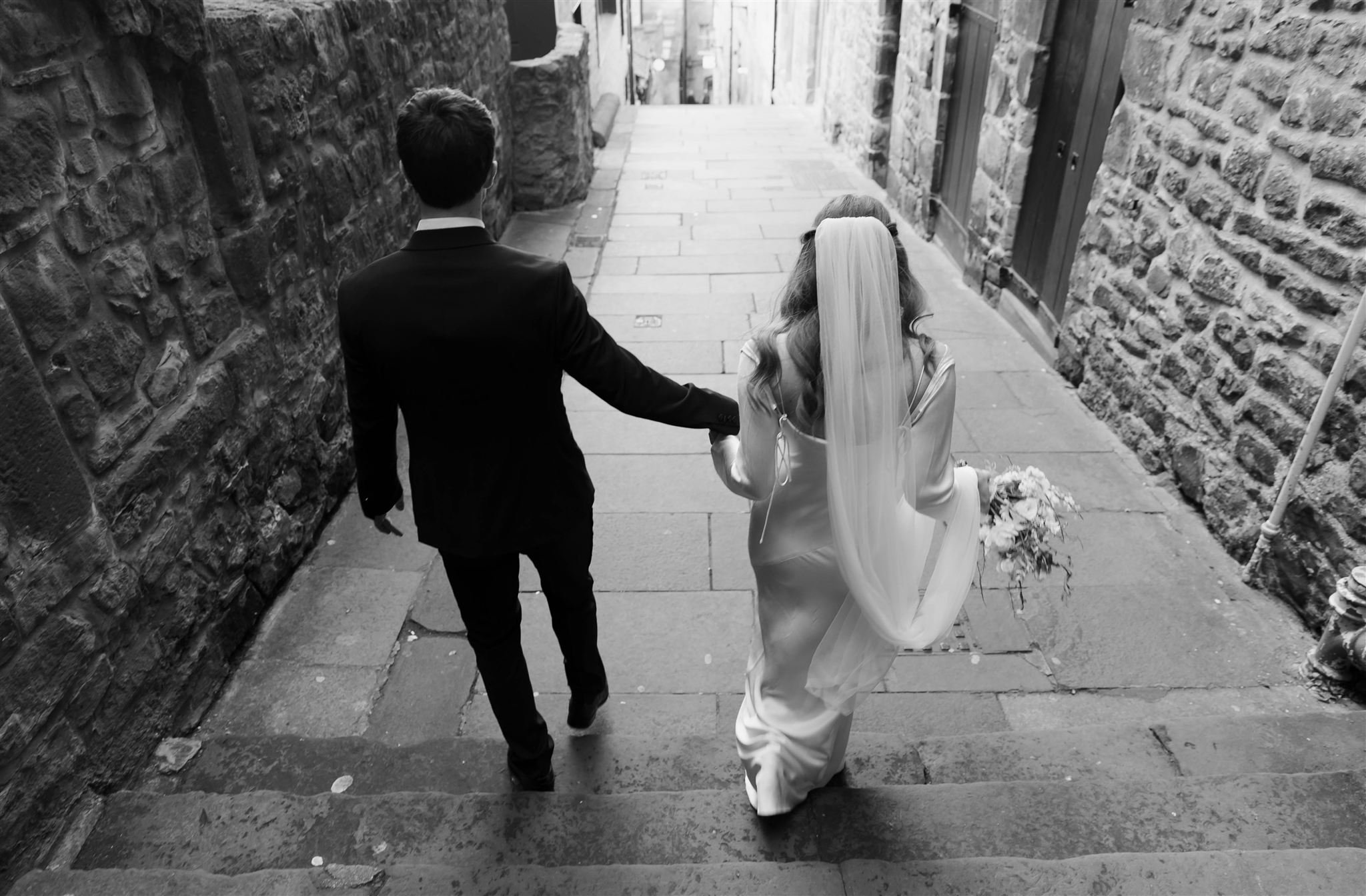 Wedding couple celebrating outside Edinburgh City Chambers, captured by an Edinburgh City Chambers wedding photographer in a casual style.