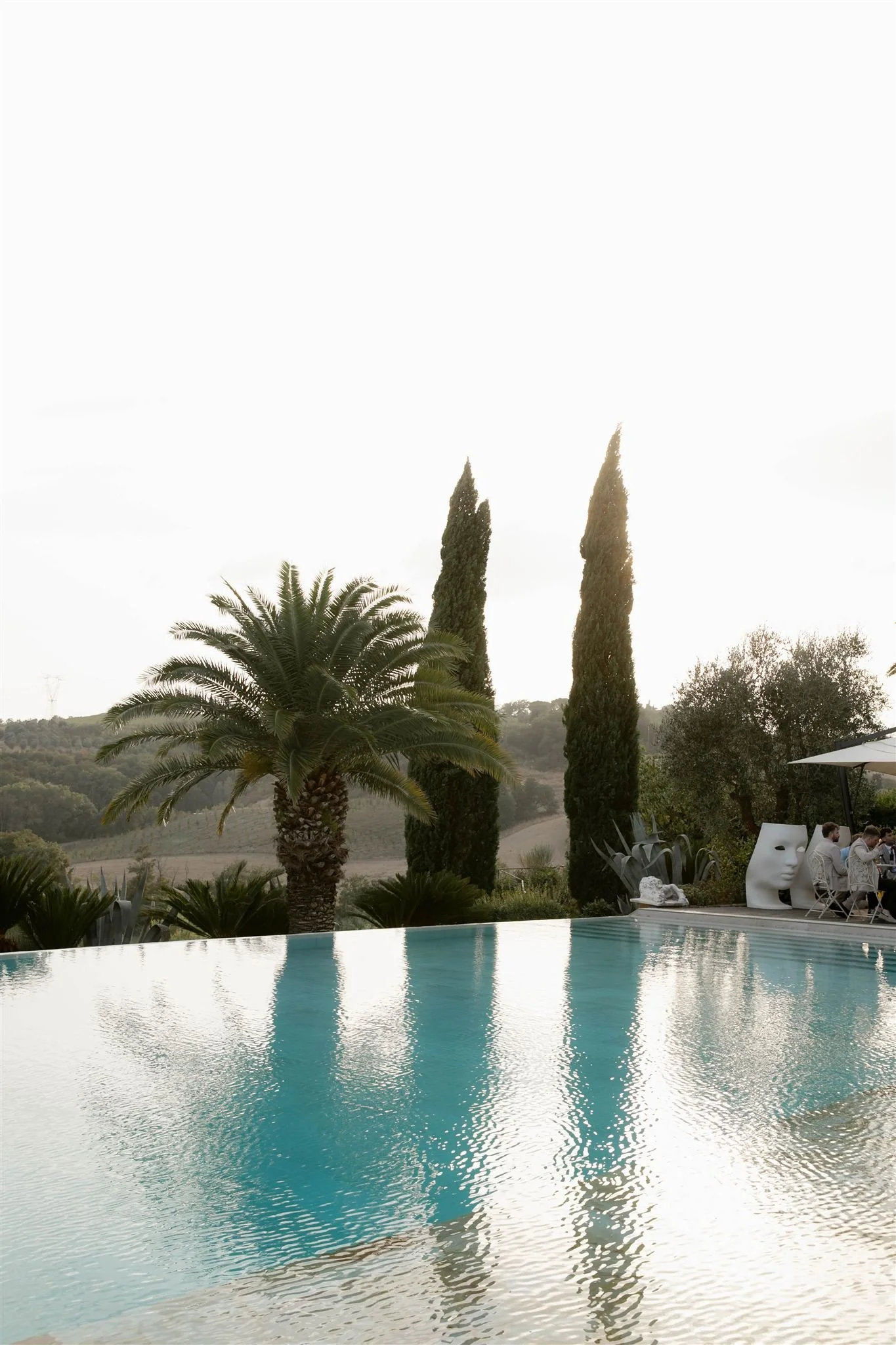 A poolside cocktail hour on a wedding day at Tenuta Corbinaia Villa in Tuscany, Italy.