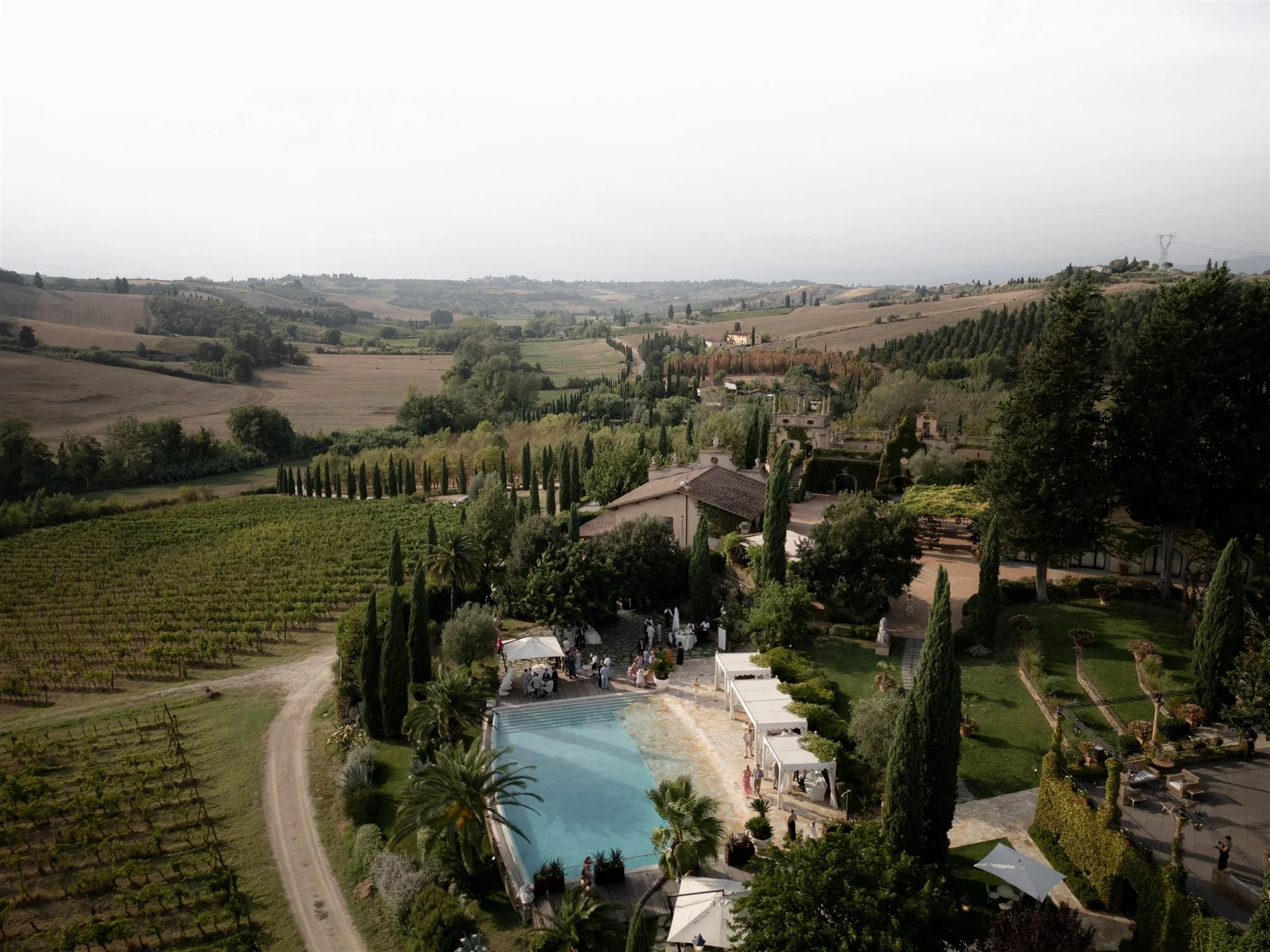 A poolside cocktail hour on a wedding day at Tenuta Corbinaia Villa in Tuscany, Italy.
